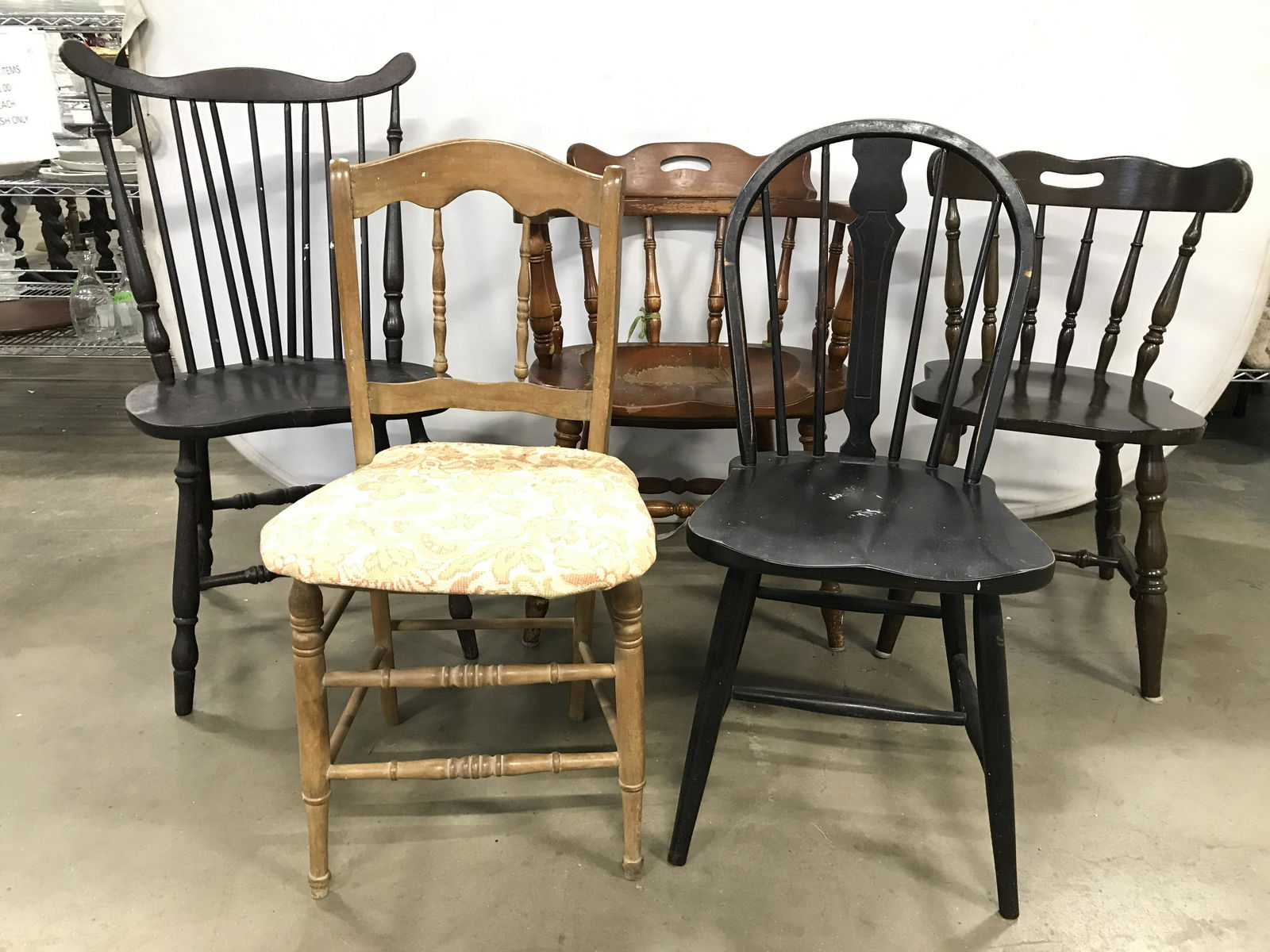 Lot 5 Antique Revival Country Chairs: Lot includes 5 chairs. Each are wooden. 4 of 5 chairs have spindle backrests. Each appear to possibly be handmade. All chairs have stretchers in between legs. One chair has caned seat with cushion. Un
