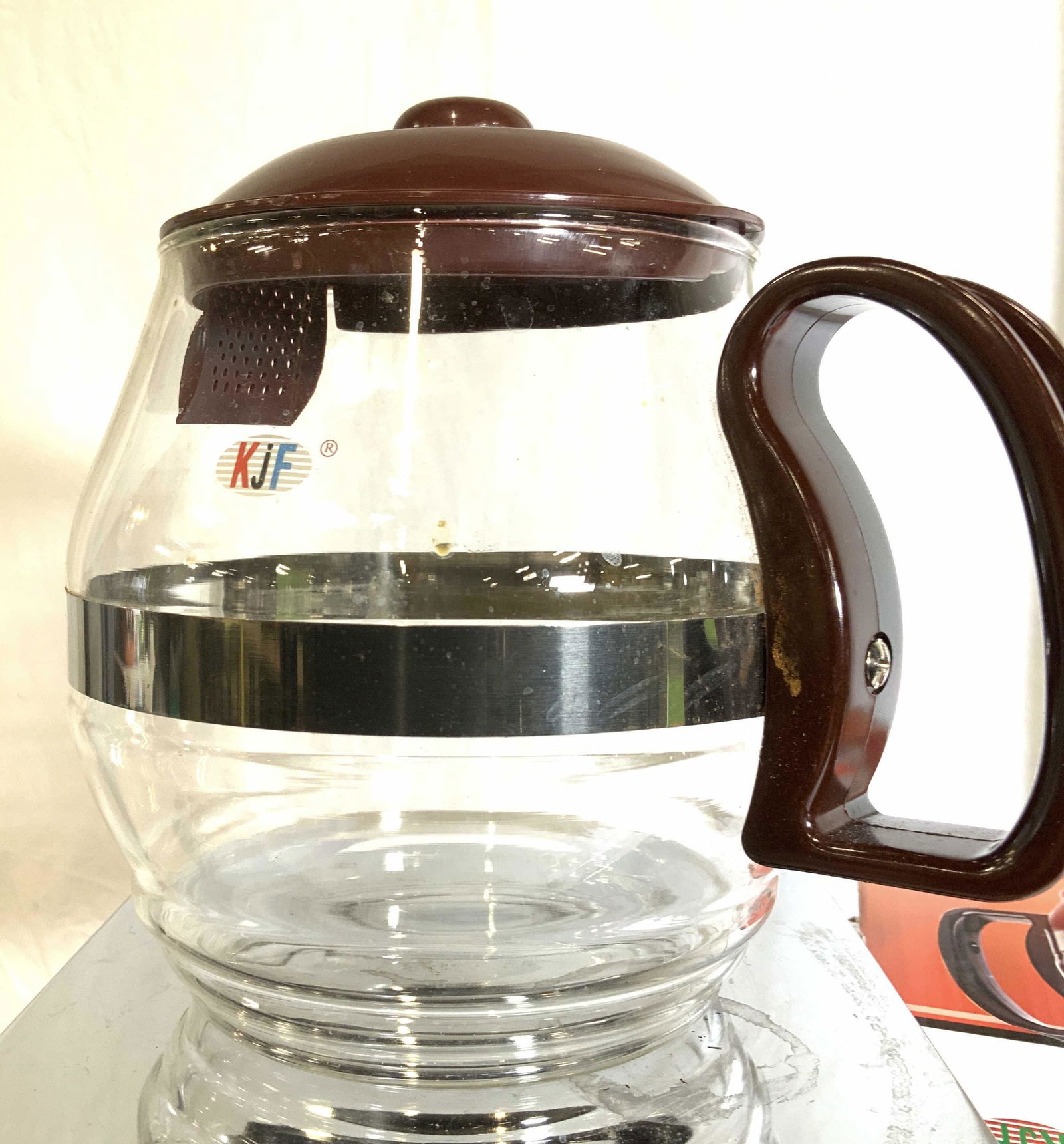 Europe Ware Heat Resistant Coffee Tea Pot, Org Box: Glass coffee or tea pot with lid, comes in original box with instructions. Item # 666D1. Heat resistant . 7 in. Ht, 8 in. W. Holds 1800 ml/ 7.6 cups. Properly of Multi Generation Brooklyn Collector’