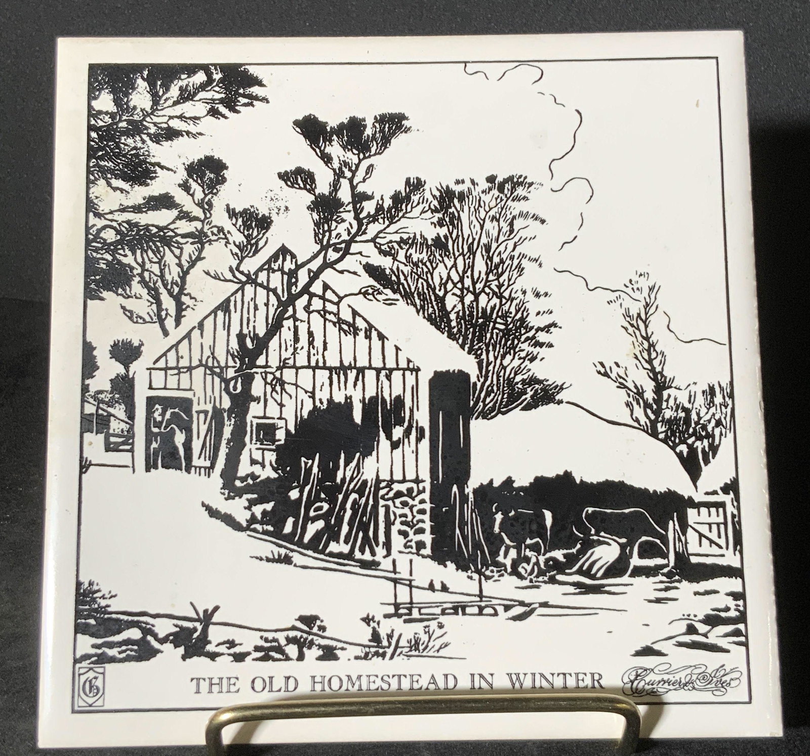 Signed CURRIER & IVES Homestead Ceramic Tile: A black and white ceramic tile depicting a homestead. Black portions of the piece are slightly in relief to the white. Piece reads: THE OLD HOMESTEAD IN WINTER. Signed CURRIER & IVES. Underside has ha
