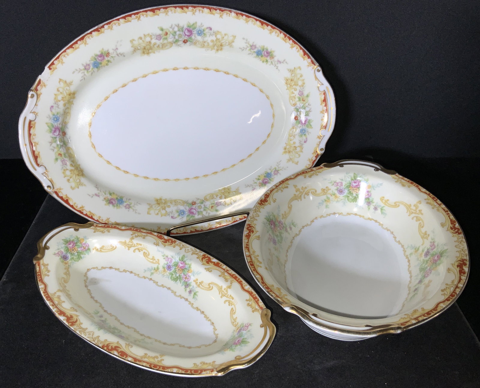 Set3 NORITAKE LINDEN Sign Porcelain Serving Plates: Three porcelain serving plates decorated with floral designs and gilt line work. Pieces are oval in shape. Light, muted yellow hues accented by muted purples, pinks, greens, and blues. Pieces have som