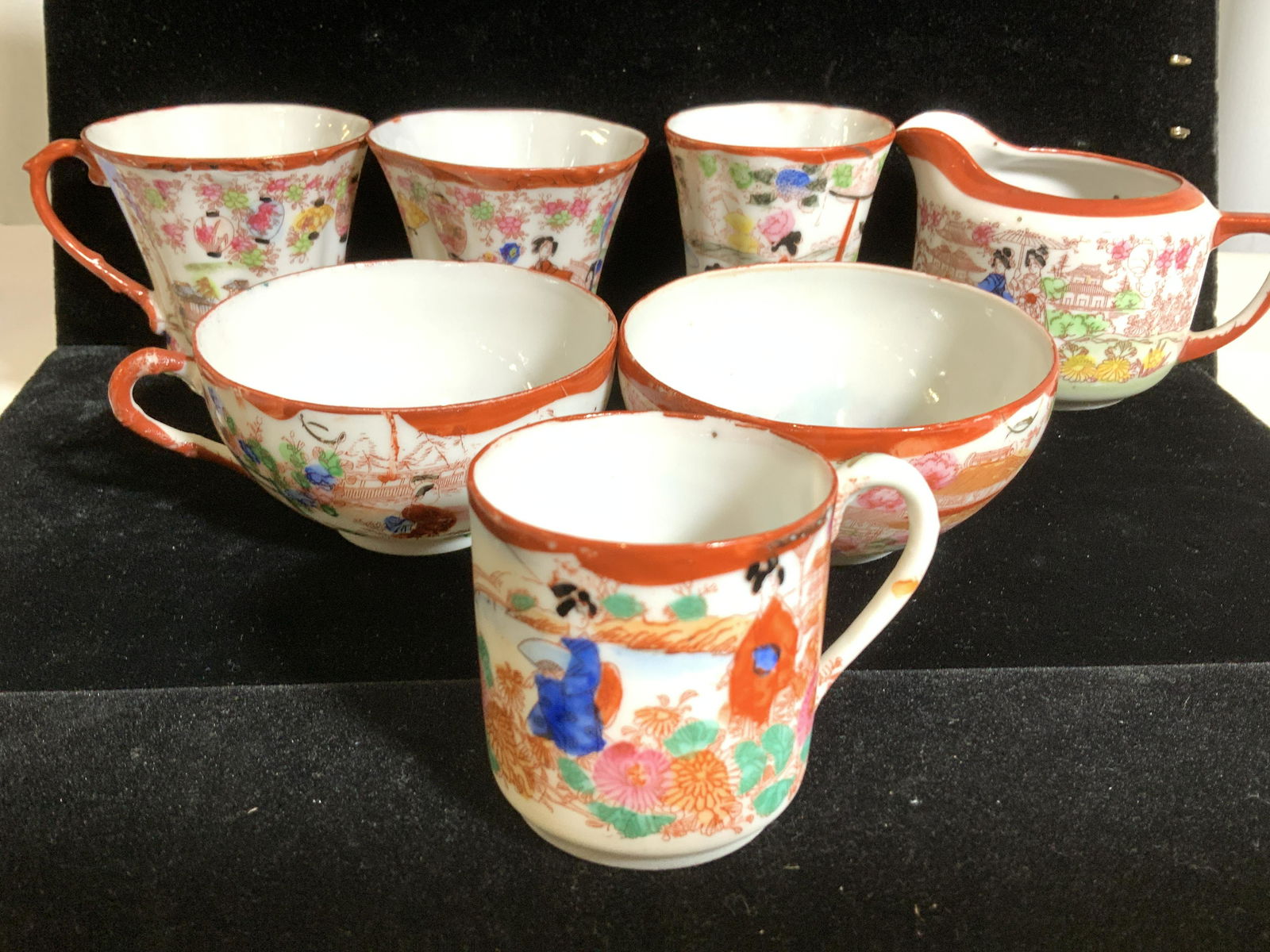 Group 7:Fine Bone Japanese Chinaware Cups, more: A grouping of demitasse and tea cups and creamer. Creamer is marked w/Japanese characters. Others unmarked. Hand painted on fine bone/translucent porcelain. Intricate detail of daily life, Japanese wo