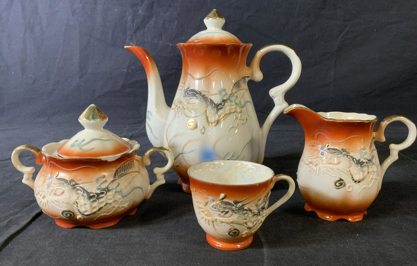 Set 7 Japanese Style Moriage Tea Service: Set 7 Japanese Style Moriage Tea Service, no apparent inscriptions or marks, teapot measures 7 3/8 inches tall x 7 1/2 inches, saucers measure 4 3/4 inches in diameter, teacup measures 2 1/8 inches ta
