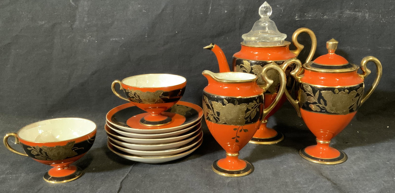 Noritake Japanese Porcelain Tea Service Set: Noritake Japanese porcelain tea service set, stamp to underside of some pieces reads ‘Noritake Made in Japan’, all pieces have an exterior of orange and black with gold accents, all have a pearles