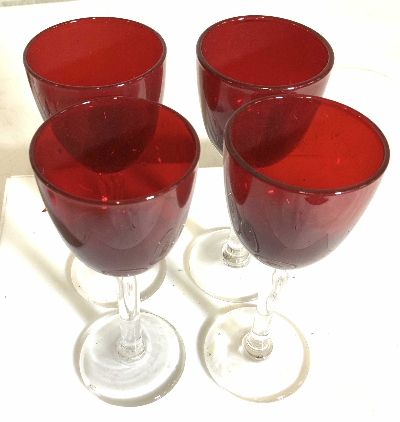 Set 4 Thick Ruby Red Glass Aperitif Stemware: Mid century modern ruby red stemware set, Popular in the 1970s, vintage thick walled deep ruby goblet with clear glass stem. glass measures 1.5. in. diameter, 5 Ht, 3.5 in. Ht. Property of Multi Gener