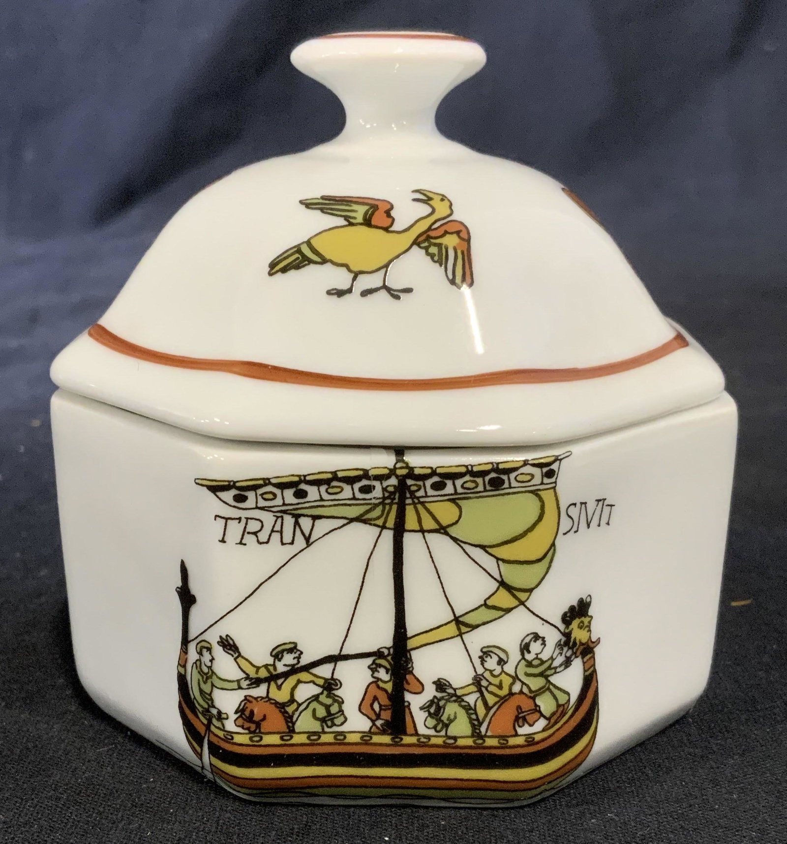 D’APRES DECORS BAYEUX Ceramic Lidded Vessel: Lidded ceramic vessel, possibly vintage. Depicts men crewing a dragon boat, TRAN SIVIT, is written above the boat. Illustration depicting various animals decorate the lid. The underside is trademarked