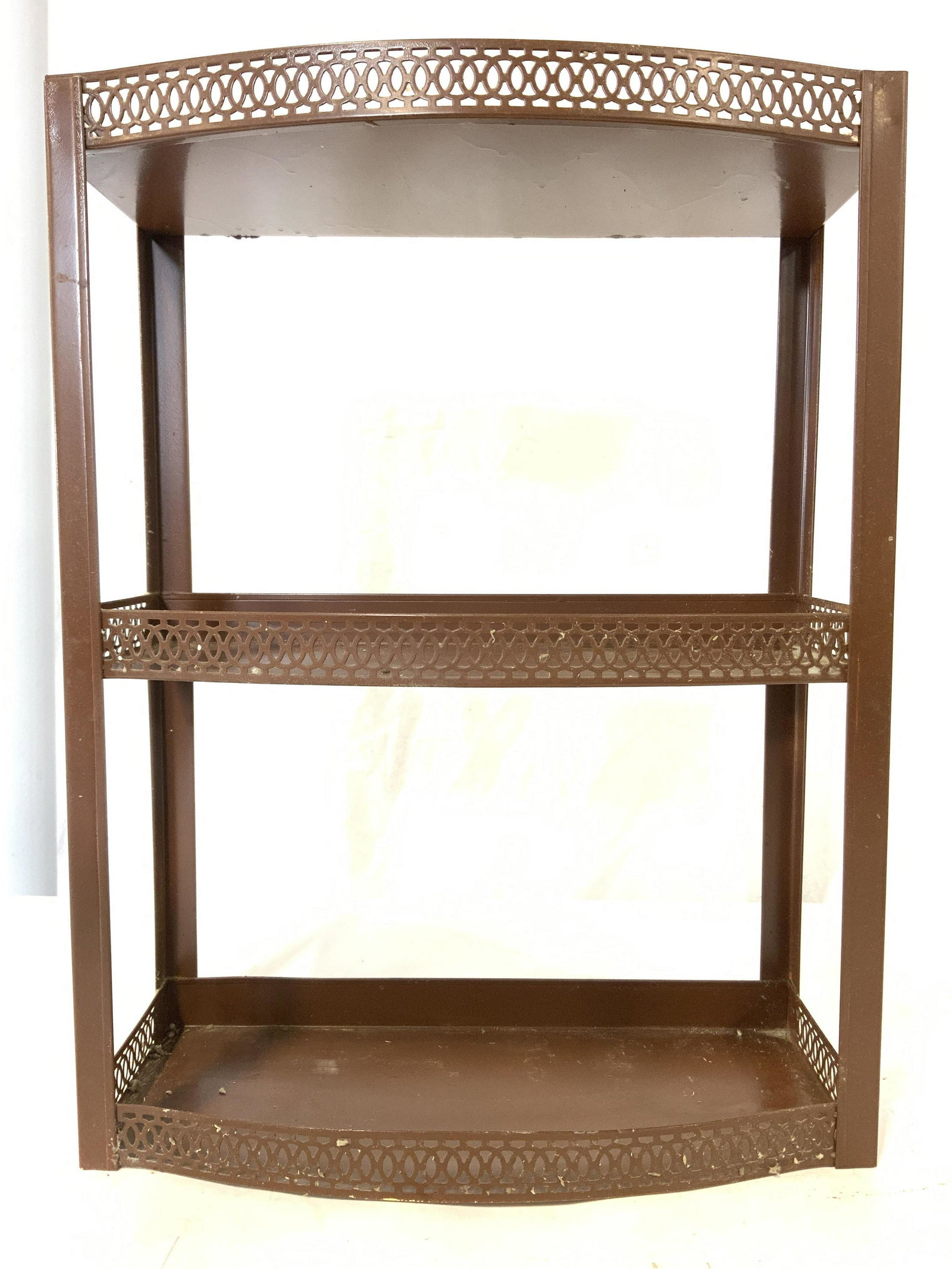 Vintage 3 Tier Metal Wall Shelf: Wall shelf is brown toned and metal. Piece has 3 tiers. Each tier has gallery. Shelf, wall shelf, metal wall shelf, vintage wall shelf, vintage shelf. Piece measures approx 16 inches tall 12 inches wi