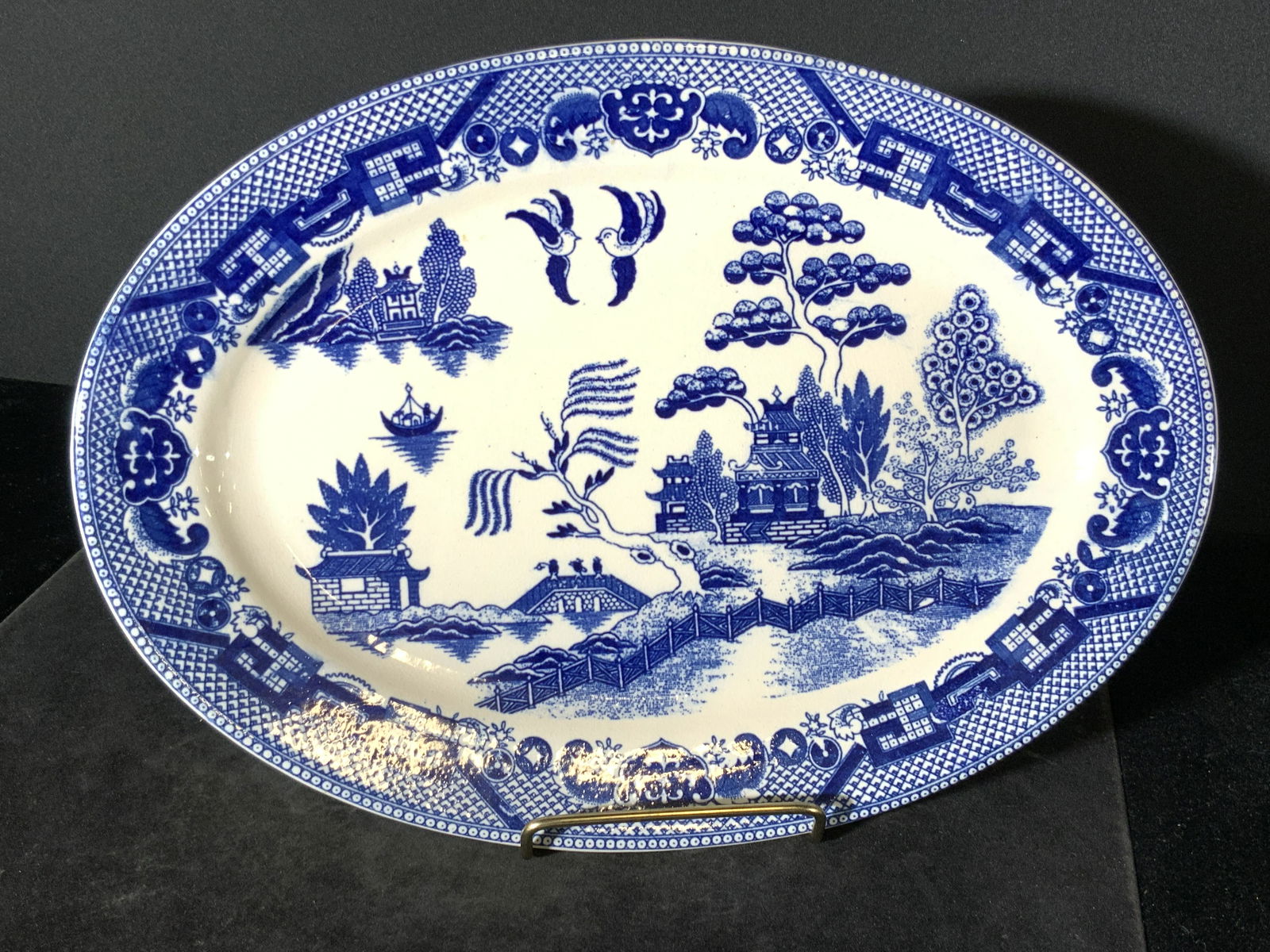 Collect Blue & White Porcelain Serving Dish, Japan: Thick walled blue and white porcelain serving dish depicting Asian style motifs. Transferware designs depicting a Pagoda / temple in a nature setting alongside two soaring birds, a boat, and fishermen