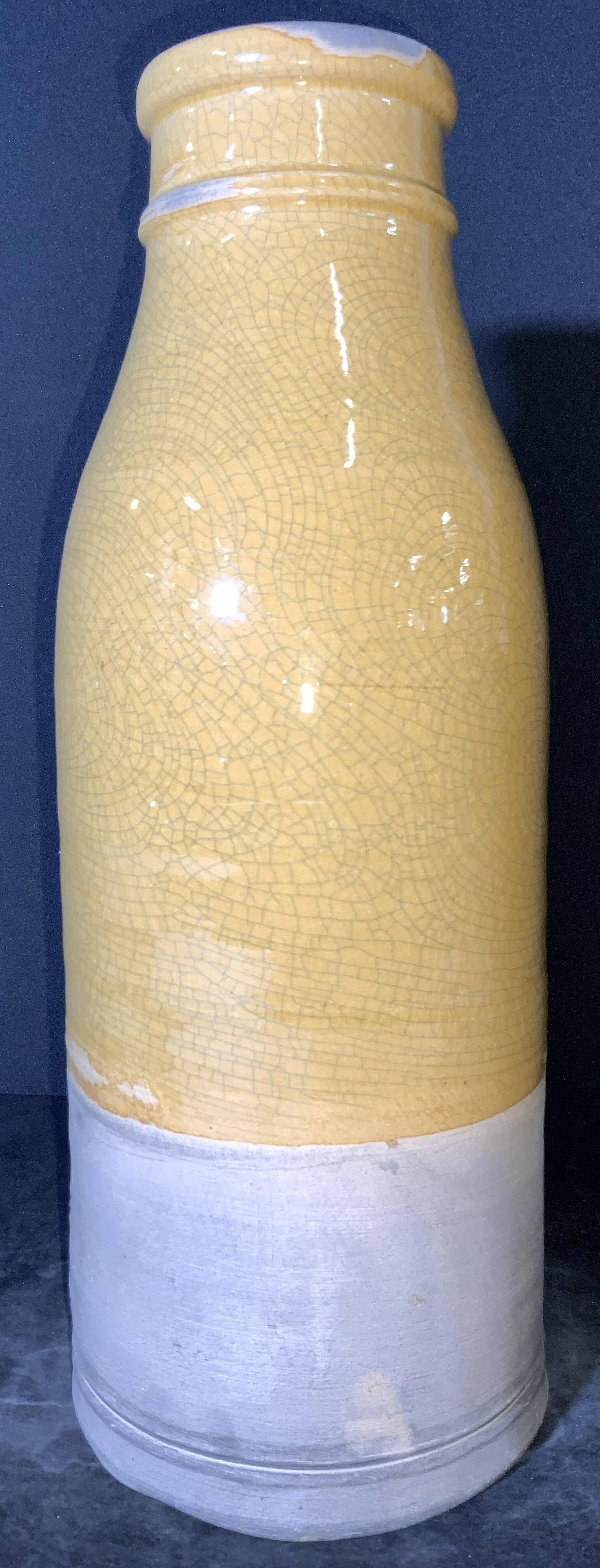 Vntg EA ROWE POTTERY WORKS Tall Ceramic Vessel: A vintage thick walled half yellow glazed ceramic vessel. The piece resembles the form of a milk bottle. Crazing throughout the glaze. Signed ED, RPW (Ethan Allen, Rowe Pottery Works). Mild wear due t