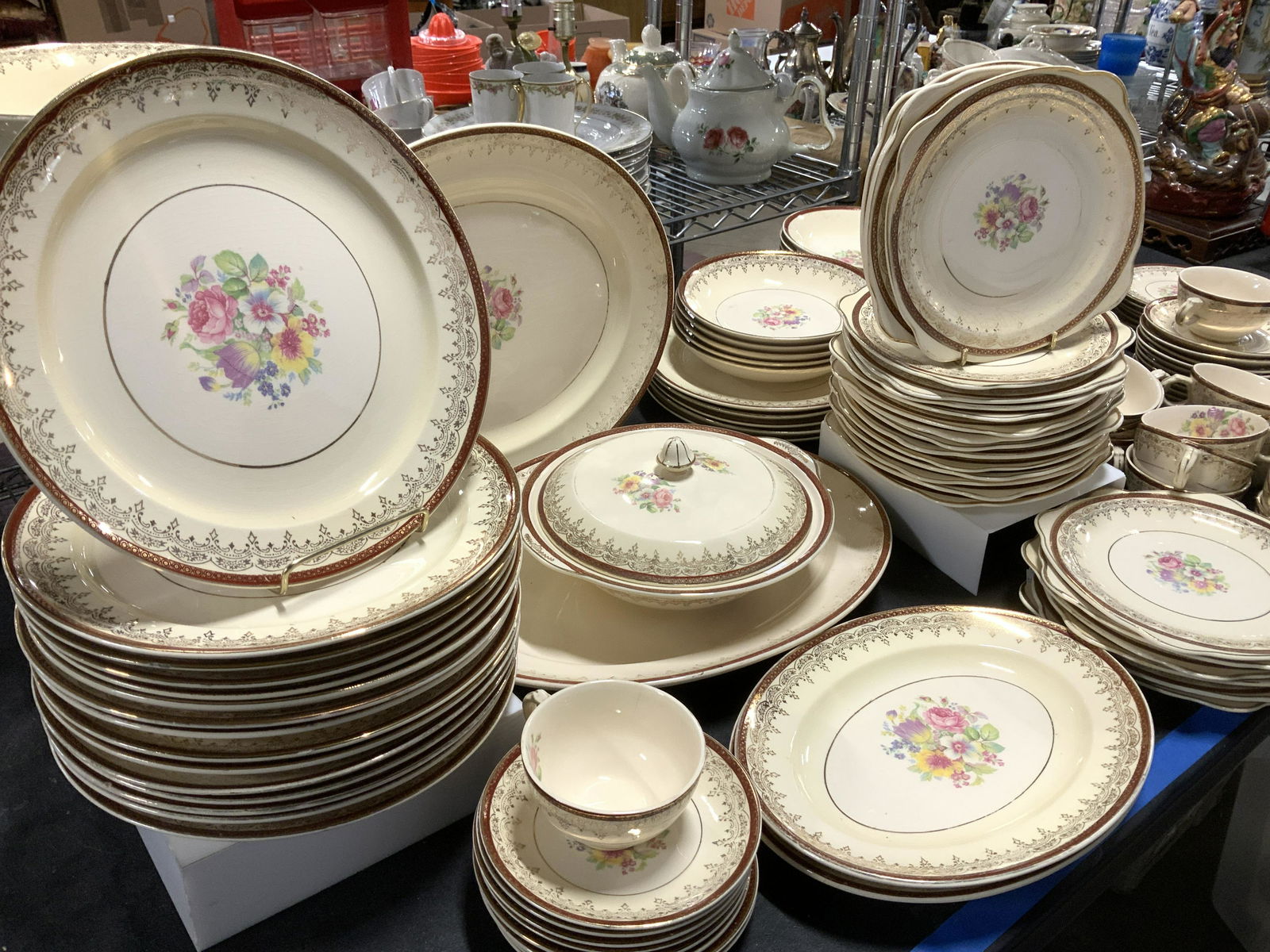 STETSON CHINA CO. 22 K G Dinnerware Set 132: Beige porcelain dinner ware set with colorful roses and flower pattern, mahogany Victorian border , gilt rim of 22 K gold. Major Pieces are Hallmarked Stetson China co. Warranted 22k gold made in USA.