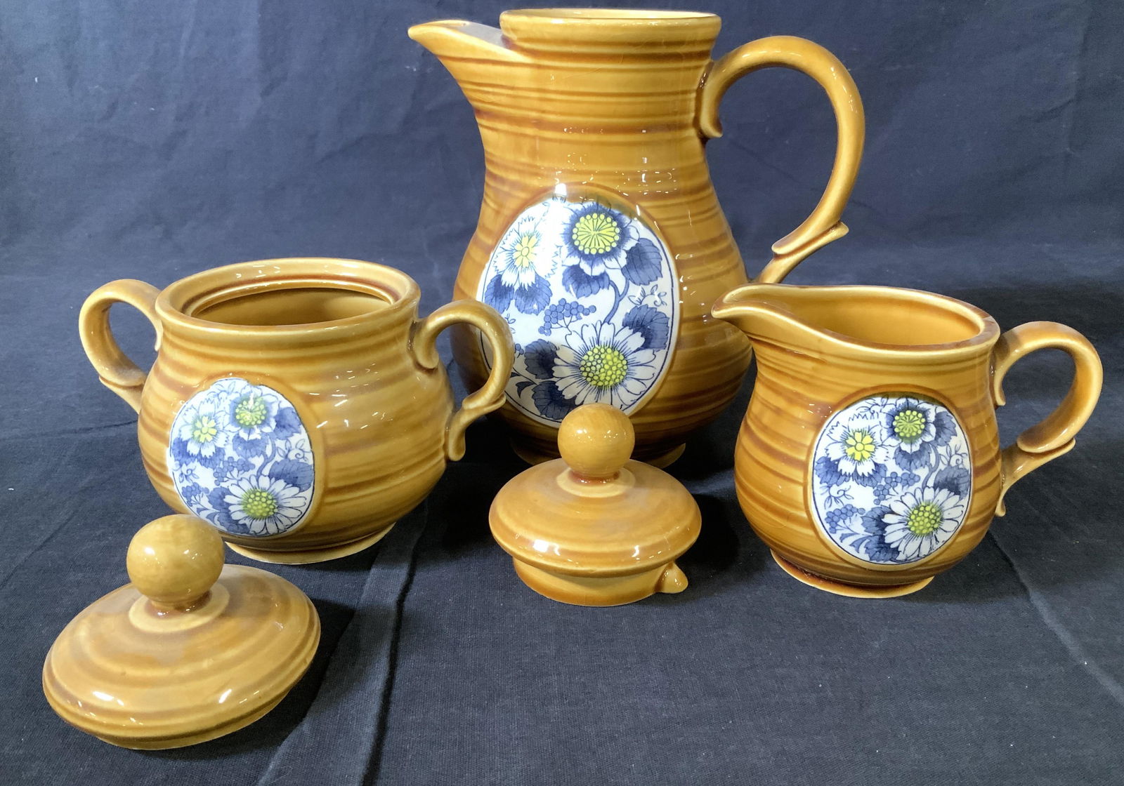 Vintage Ceramic Tea Service Set 7: Vintage earthenware pottery, pottery wheel pattern, with center medallion of blue flowers on white porcelain. Tea pot with lid, creamer, sugar bowl with lid and 4 cups. Great for coffee as well. Tea p