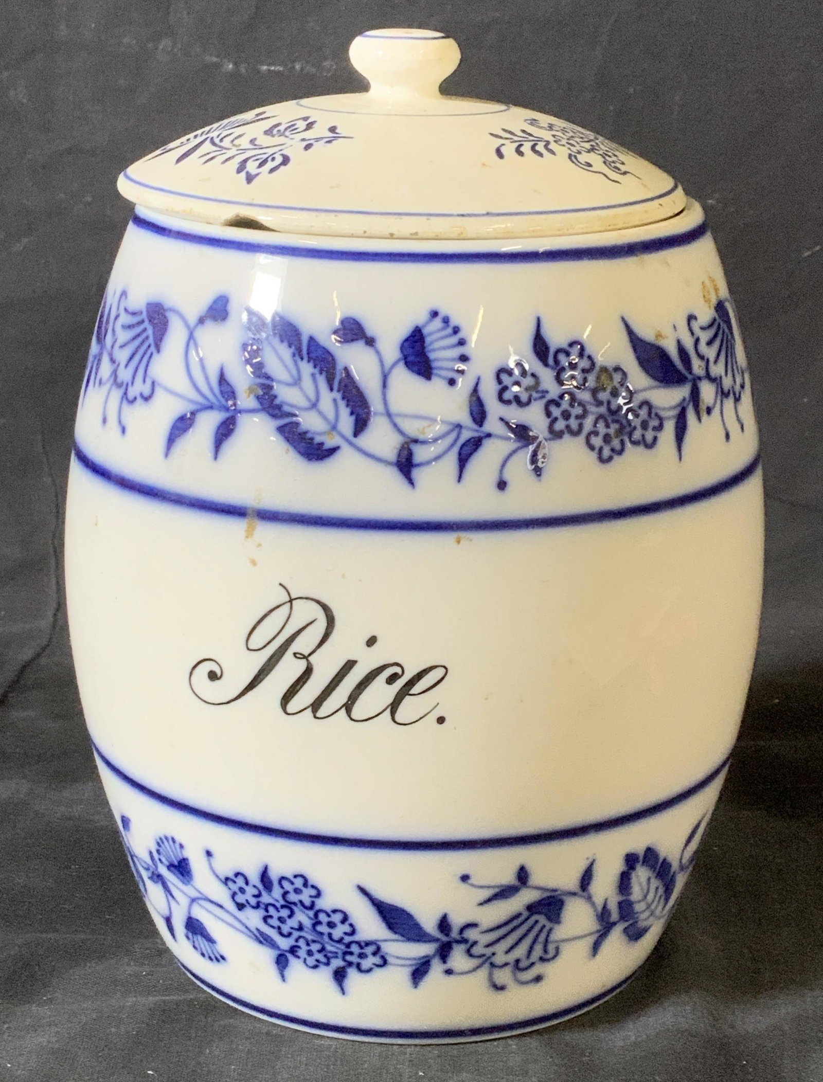 Porcelain Blue & White Rice Canister: Kitchen counter canister, made of porcelain, Hallmarked Germany, reads Rice on vessel. Has lid not original to piece. Chip to lid. 7.5 in. Ht, 6 in w. Up cycle Porcelain, ceramics, rice holder, kitche