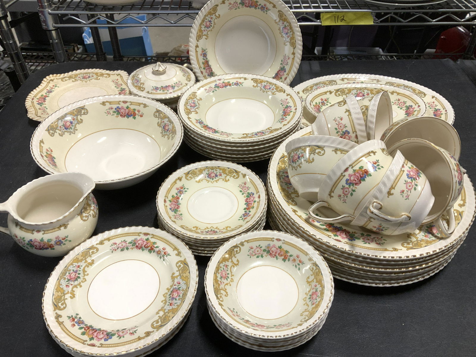 Old English Johnson Bros Partial Dinnerware Set 43: Set Victorian Motif Porcelain Dinnerware Set with Scrolls and pink roses on cream colored porcelain . Partial set consists of 10 dinner plates, 1 round serving bowl, 1 med sized platter, 1 small platt