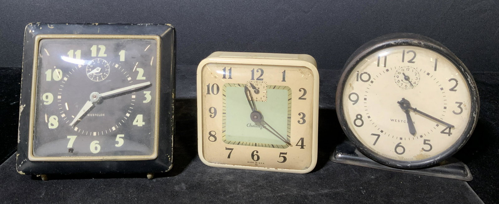 Lot 3 Vintage Tabletop Clocks, WESTCLOX & More: Three collectible vintage tabletop clocks. Two clocks are signed WESTCLOX, one is signed CHALLENGER. All brands appear on the clock faces. Two clocks are square in form, one is circular. All clocks po