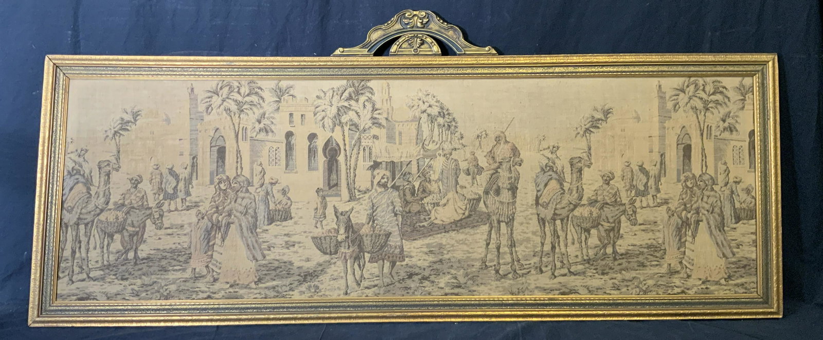 Framed Middle Eastern Tapestry Artwork: Framed Middle Eastern Tapestry, no apparent inscriptions or markings, subject a market place scene in a middle eastern setting, some pulls to fabric, gilt wood frame, measures 22.5 inches by 61.5 inch