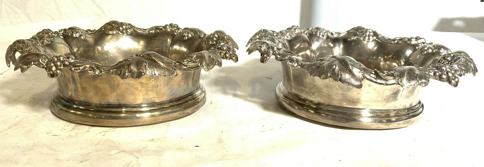 Pair Grape Leaf & Vine Wine Coasters: Lot includes 2 wine coasters, each appear to possibly be silver plated. Each are marked 329 & have trademarks in center. Each piece has intricate grape, vine & leaf detail around rims. Each measures a
