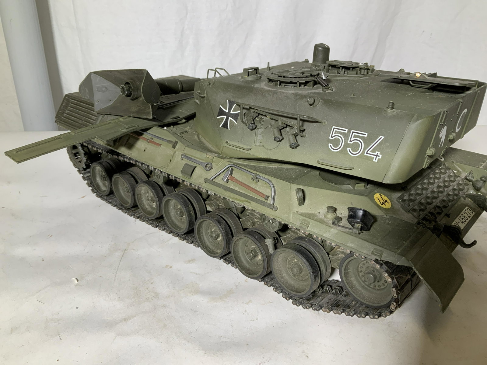 Collectible German Military Army Toy Tank: TAMIYA GERMAN PANTHER Large Army green Tank, on/ off switch, has German flag license plate Y-458273. Other stickers with numbers such as 44, 6, Panther SILOUETTE, Labeled tank 554. Combo of metal and 