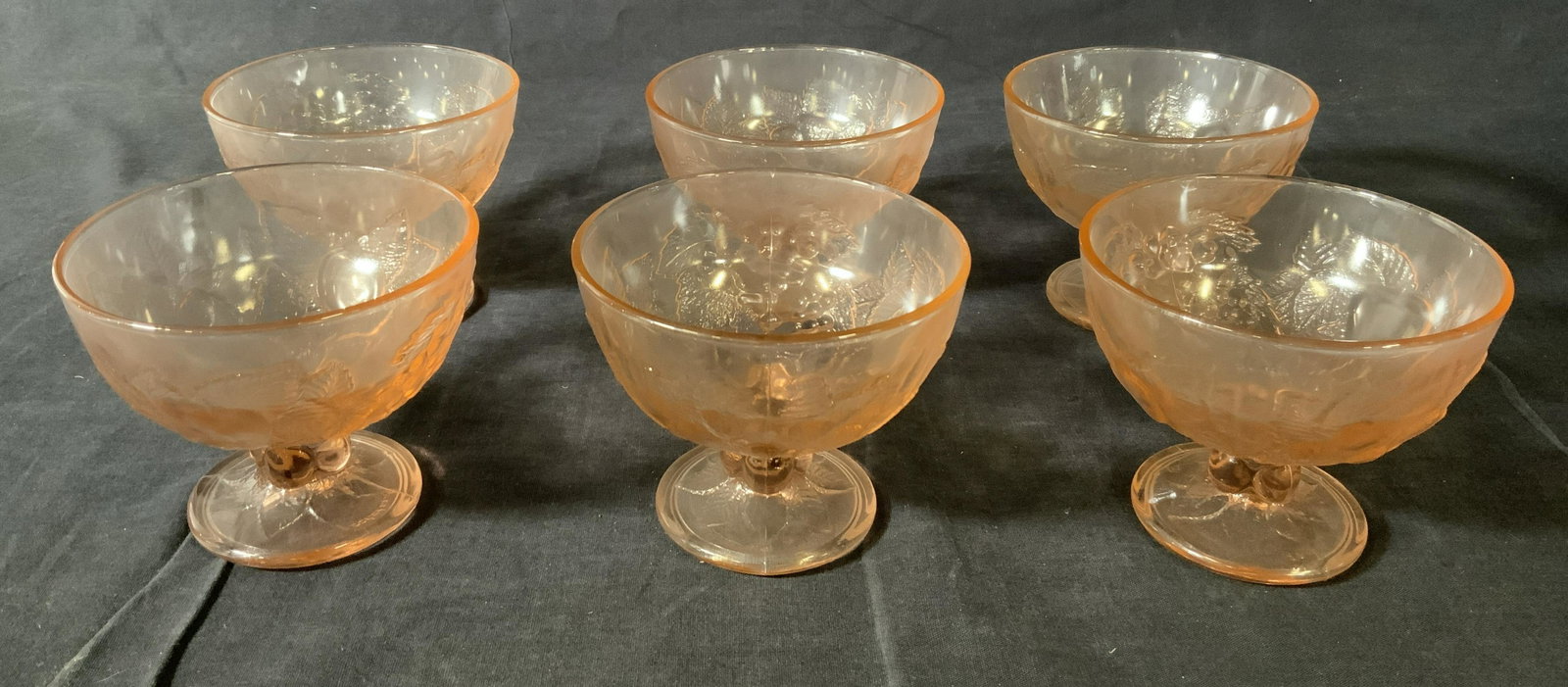 Set 6 Depression Glass Pedestaled Bowls: Set 6 Depression Glass Pedestaled Bowls, inscription to base, one illegible, other reads ‘39’, all measure 3 3/4 inches tall x 4 1/2 inches in diameter, some surface wear to pieces, Property of mu