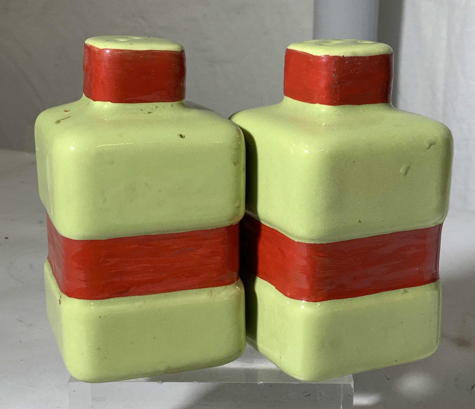 Pair Ceramic Lime & Red Salt & Pepper Shakers: Hand painted and glazed Red and lime colored salt and pepper shakers with cork stoppers. 4.5 in ht, 2.5 in. L & W Property of Multi Generational Brooklyn Collector’s Estate, A Collector’s vintage 