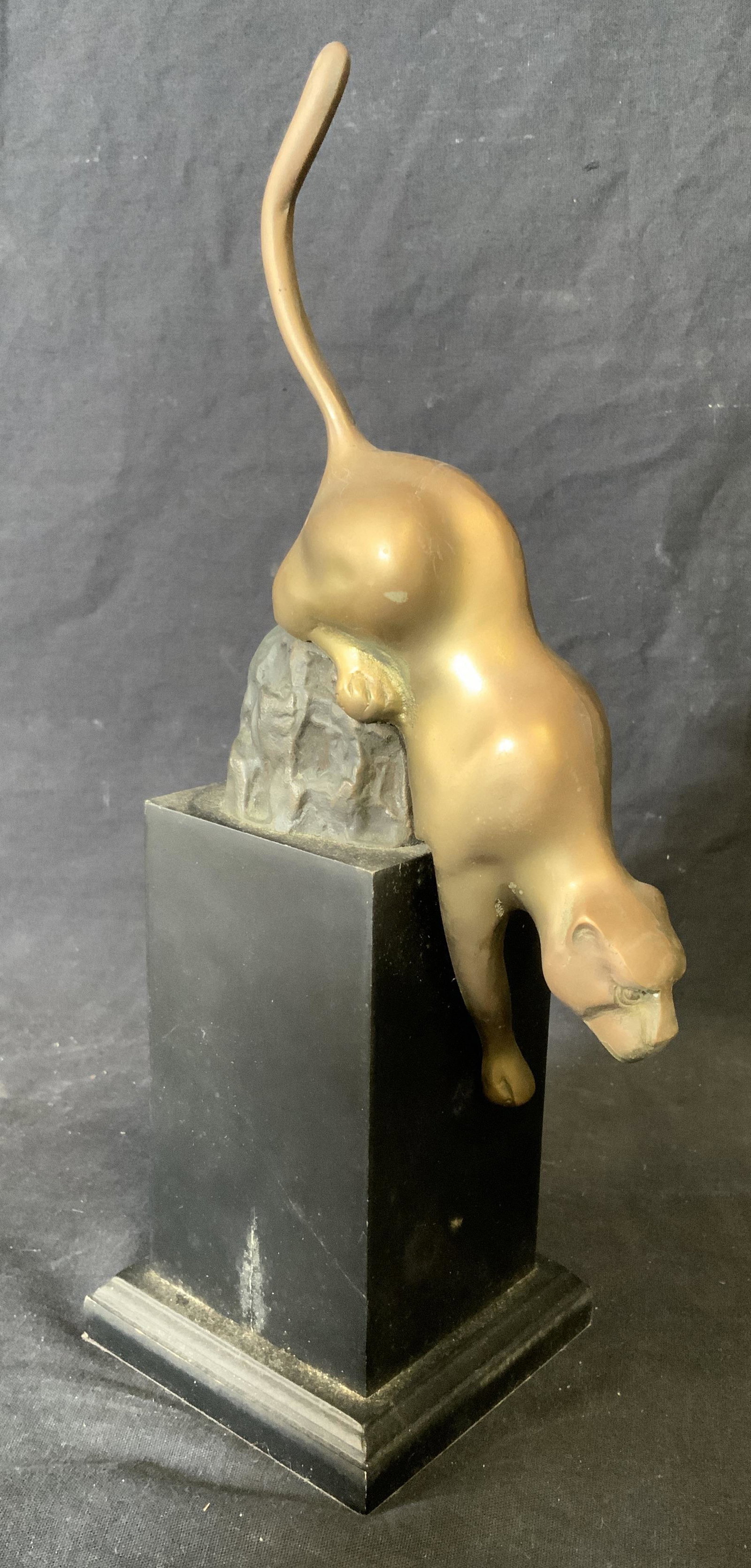 Metal Panther Sculpture on Wooden Base: Metal Panther Sculpture on wooden base, no apparent inscriptions or markings, subject a bronze toned metal panther about to pounce from its base, piece measures 12.5 inches at tallest point, on a blac