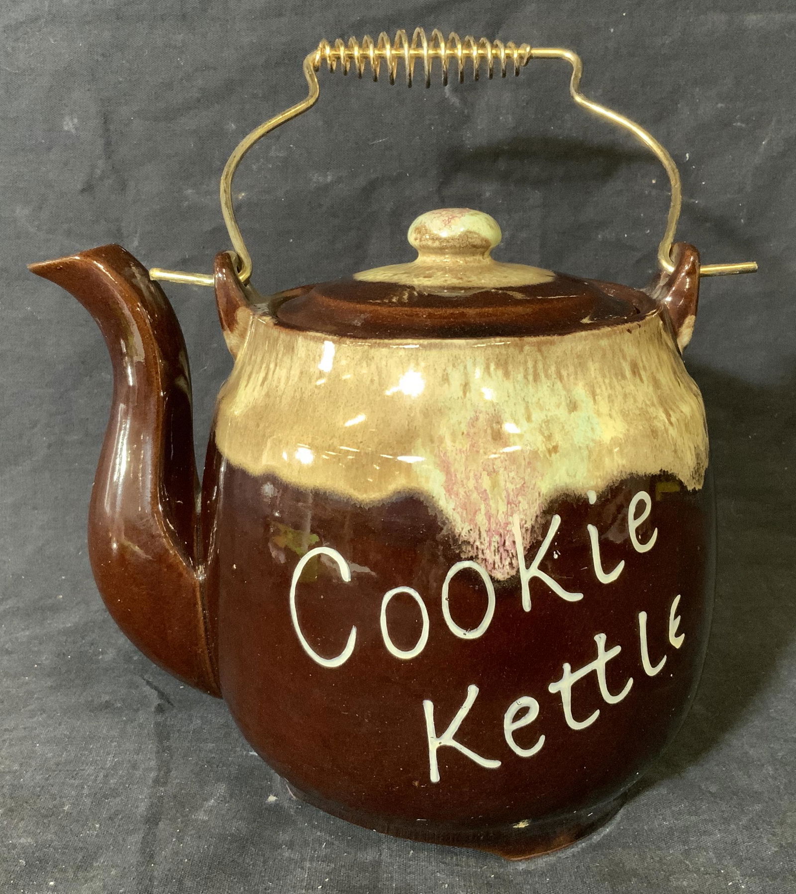 Ceramic Cookie Kettle: Ceramic cookie kettle, no apparent inscriptions or tags, label to exterior reads ‘Cookie Kettle’, has metal wire handle, some wear to surface, measures 9.5 inches at tallest point with handle, pro