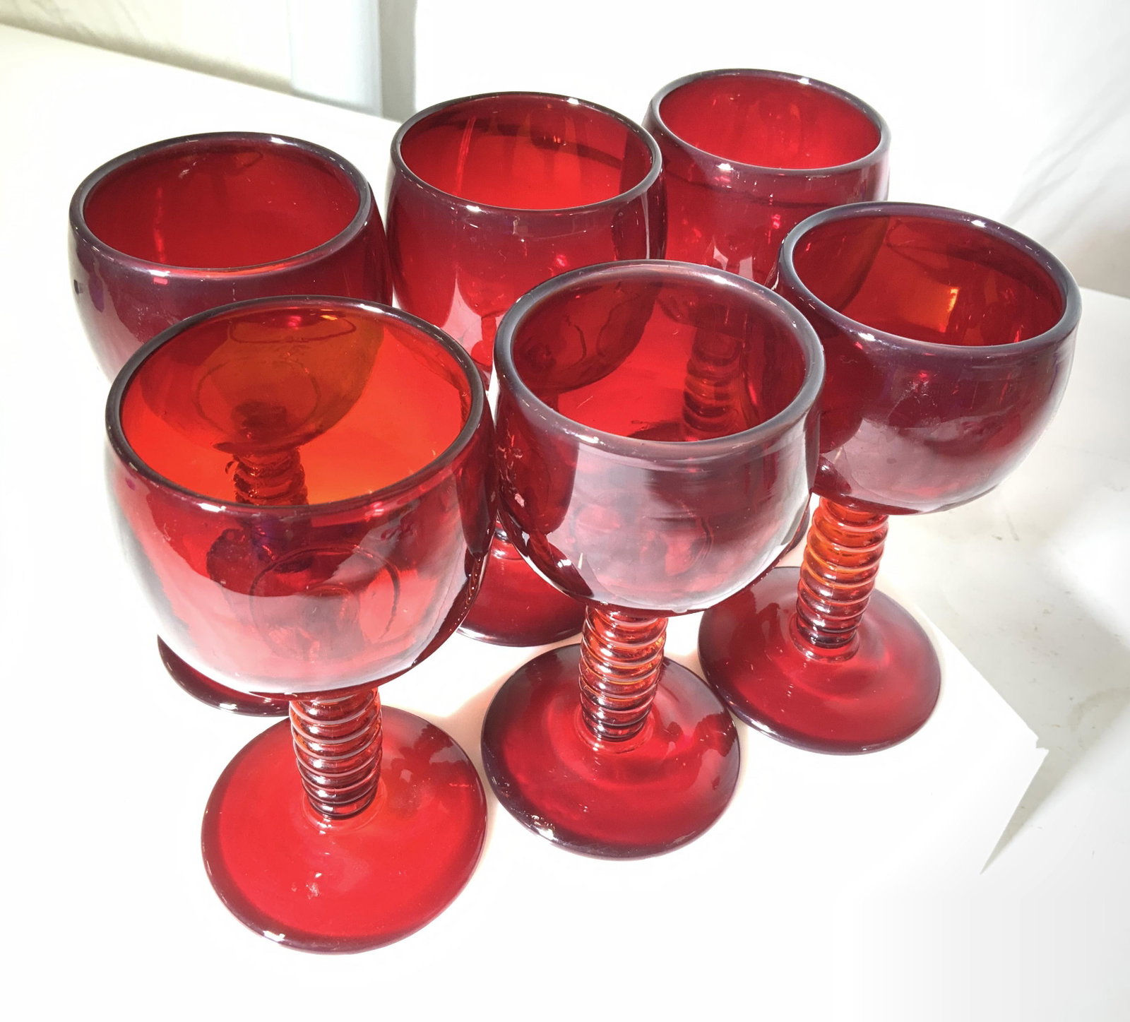 Set 6 Mid Century Ruby Red Stemware: Mid century modern ruby red stemware set, vintage thick walled deep ruby goblet with twisted Ruby red stem. measures 5 Ht, 2.5 in. W Property of Multi Generation Brooklyn collector’s estate , From C