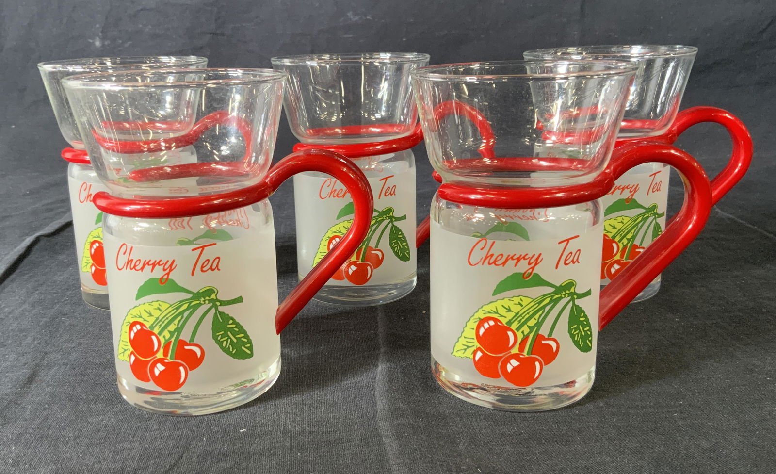 Set 5 INSPIRATION Glass Cups: Set 5 INSPIRATION Glass Cups, inscriptions reads ‘Inspiration’ and ‘Cherry Tea’, all measure 4 3/8 inches tall x 2 7/8 inches at widest point, some surface wear to pieces, Property of multi ge