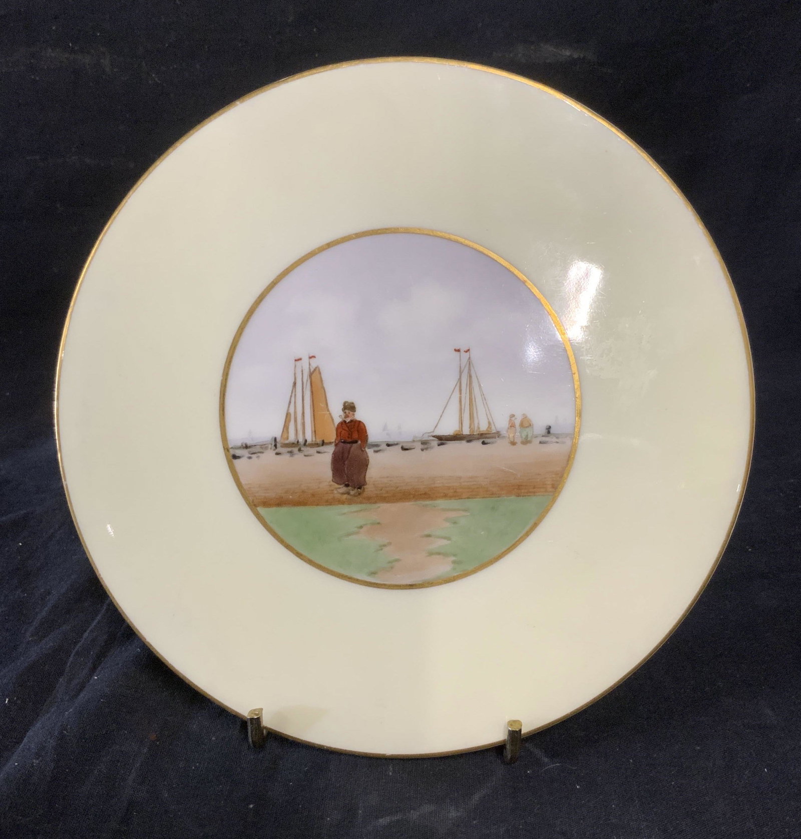 Hand Painted LENOX Ceramic Trivet: Vintage hand painted LENOX trivet, Depicts a man standing at a pier. Measures approx 8 inches in diameter. Underside reads as LENOX FREDERICK KEERS SONS, NEWARK NJ. Wear is consistent with age and use