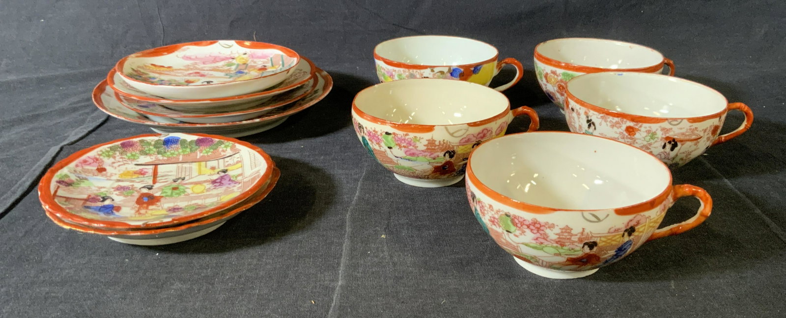 Set 10 Japanese Porcelain Teacups & Dishes: Set 10 Japanese Porcelain Teacups & Dishes, inscriptions to base read ‘Japan’, design features women in traditional Japanese clothing walking through gardens, teacups measure 2 x 3 7/8 inches in d