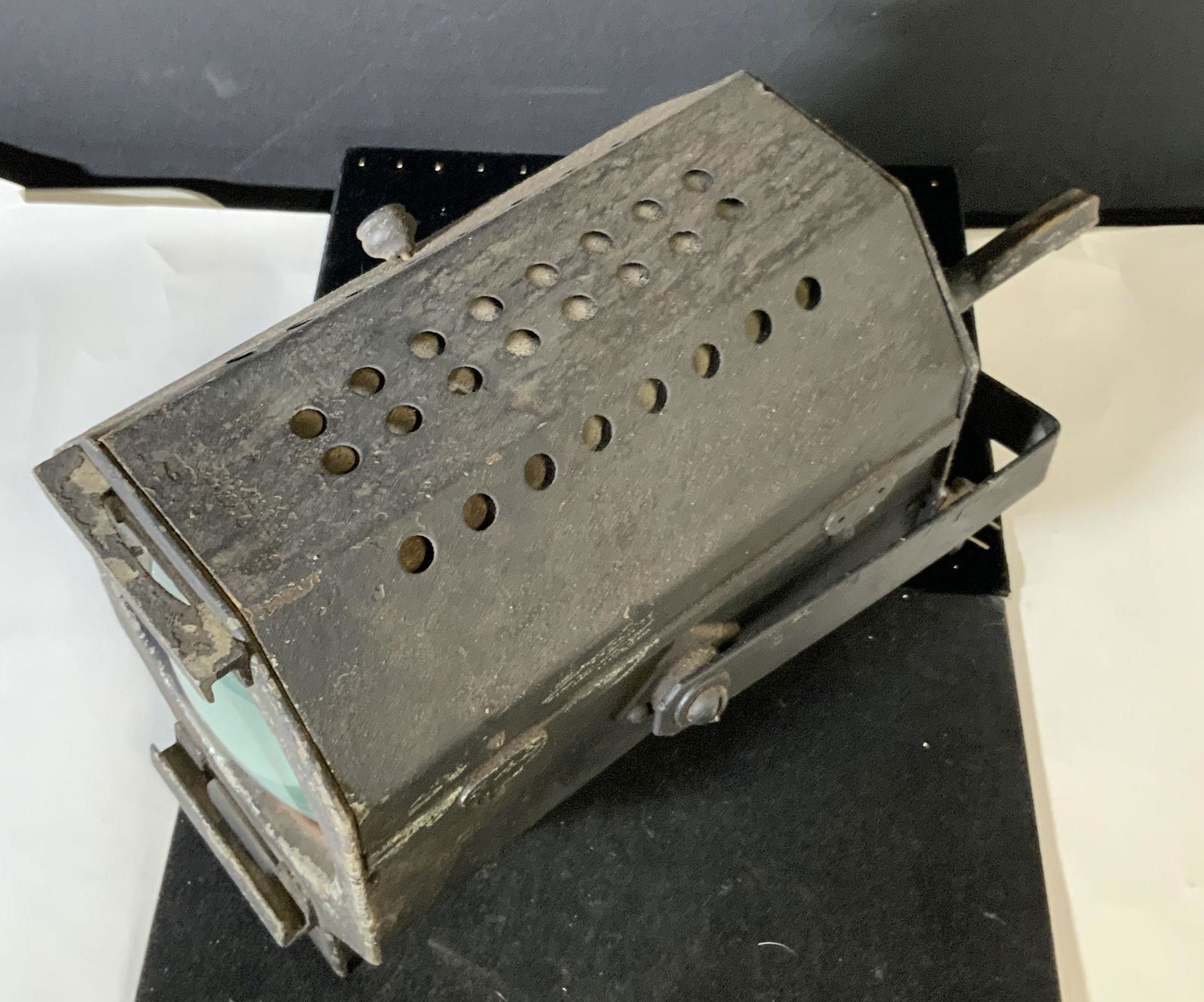 DUWICO Vintage Theatrical Spot Lot: Large theater spot light. Once used to light up stages. Heavy metal material and glass light bulb. Has short cord attached. Side of hanging device reads: DUWICO. Weighted piece. Untested. Approx. 11.5