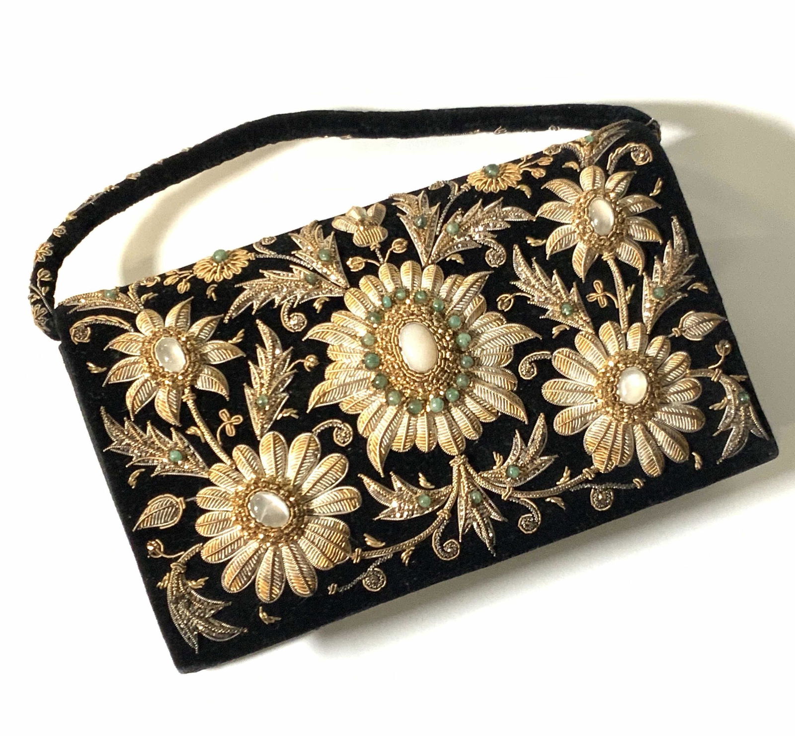 ZARI Handmade Velvet Moon Stone Emerald Purse: A black velvet purse with intricate beaded designs. Polished Emerald and cabochon moonstone gems throughout gold and silver threading. Beaded on both sides. Interior is fully lined with a smooth hand