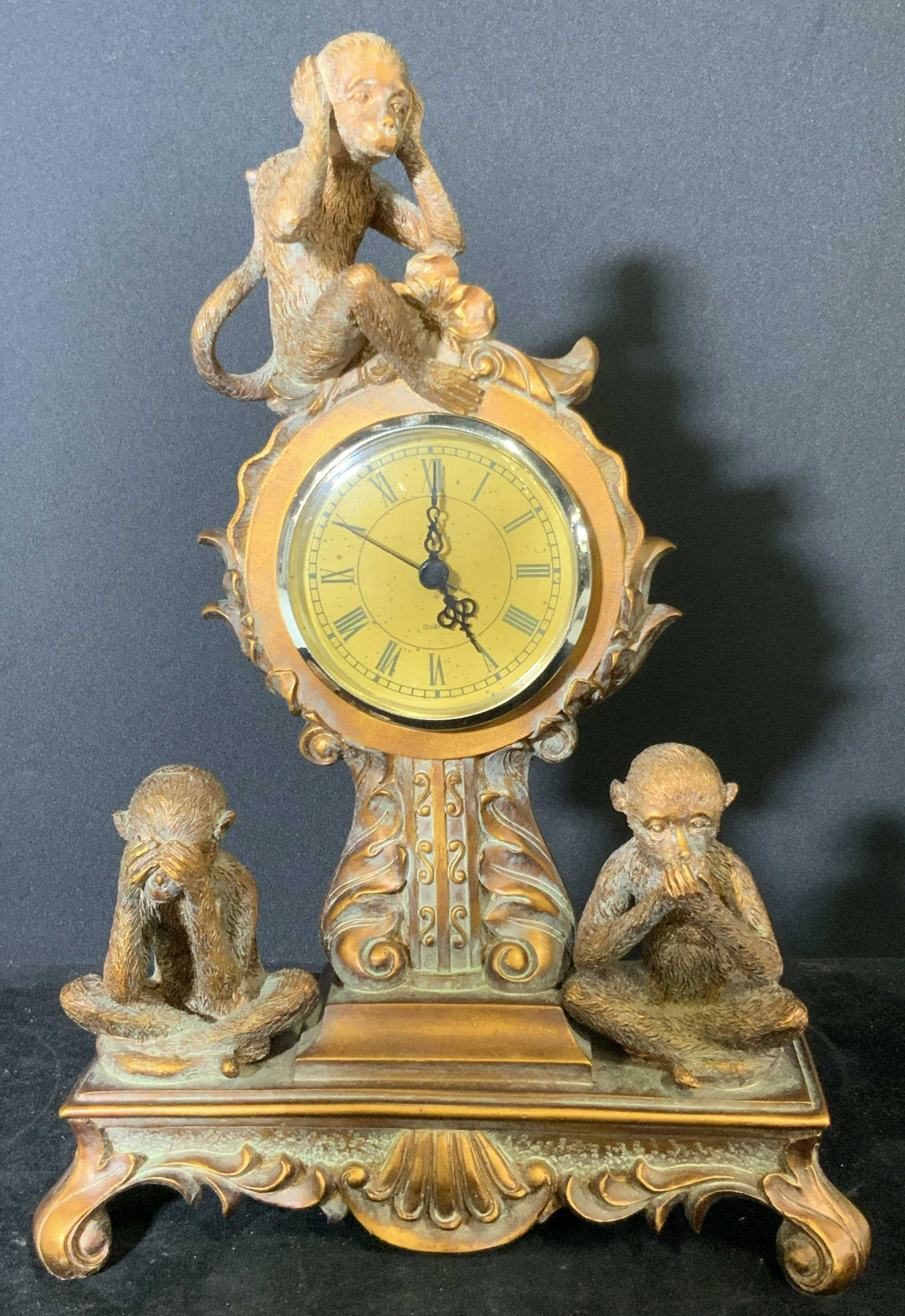 Vintage Composite Three Wise Monkeys Mantle Clock: Painted Composite footed mantle clock with Three Wise Monkeys Figural. Monkeys are depicted in the ‘ see no evil, hear no evil, speak no evil ‘ classic poses. Monkeys have etched hair and features