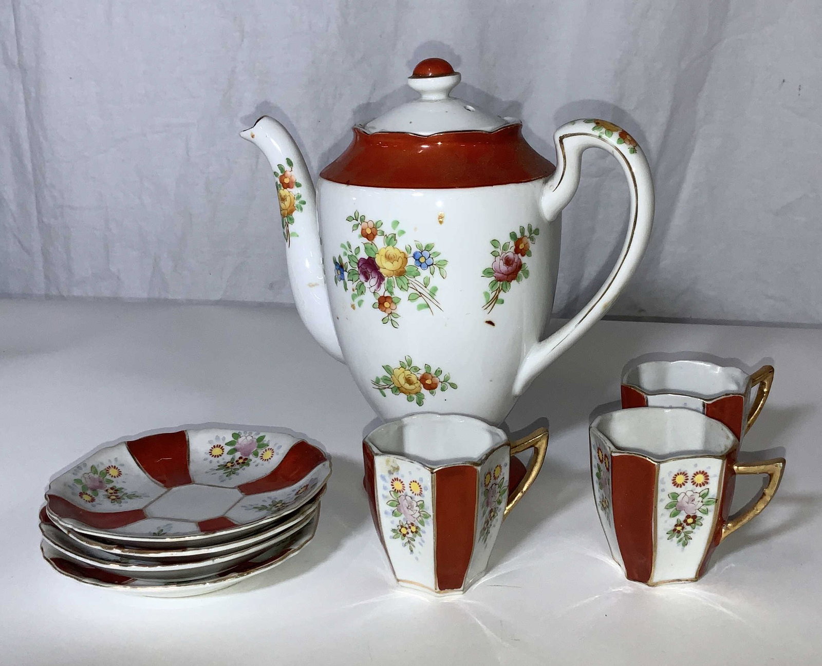 Vintage Japanese Ceramic Teapot Set 8: Japanese Ceramic Teapot, stamp to base on teapot in orange ink reads Coronation China, Japan, measures 7.5 inches tall x 8 inches at widest point, includes 3 demitasse cups and 4 saucers. All hand pai