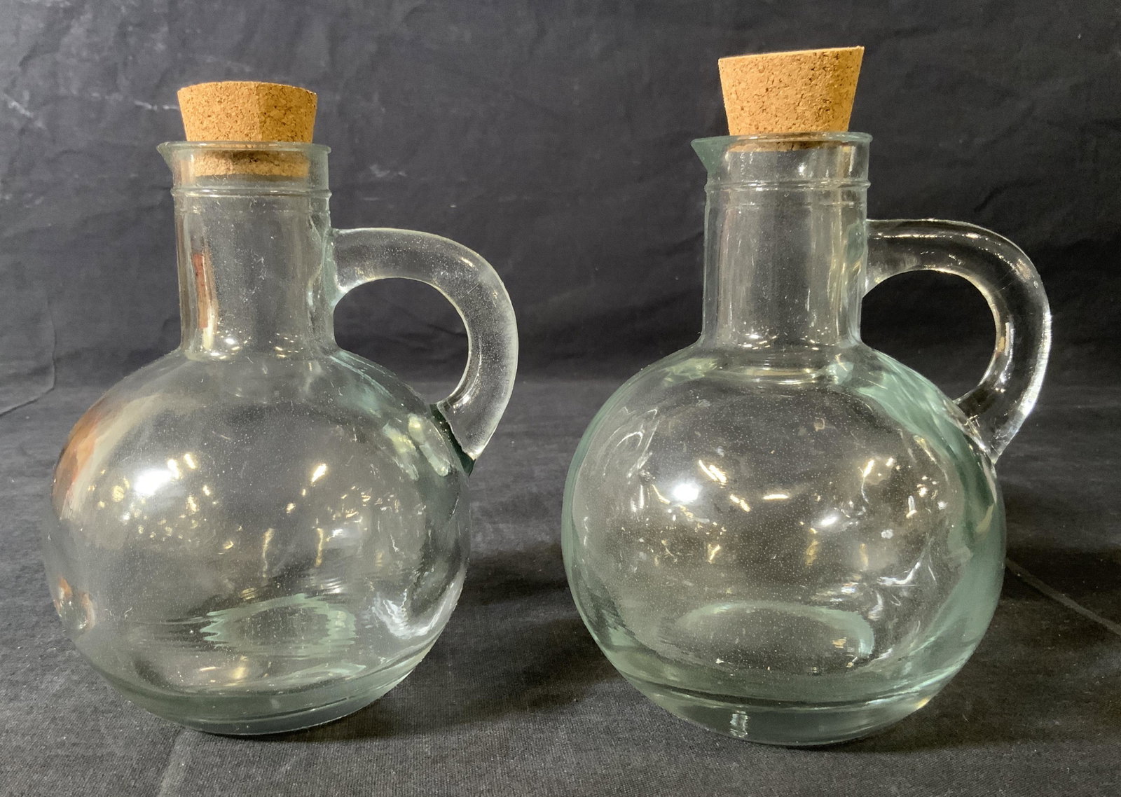 Pair Corked Glass Bottles: Pair Corked Glass Bottles, comes in original boxes, inscription to boxes read ‘Glass Bottles’, both measure 5 1/4 inches tall x 3 3/4 inches at widest point, bottles need cleaning, Property of mul
