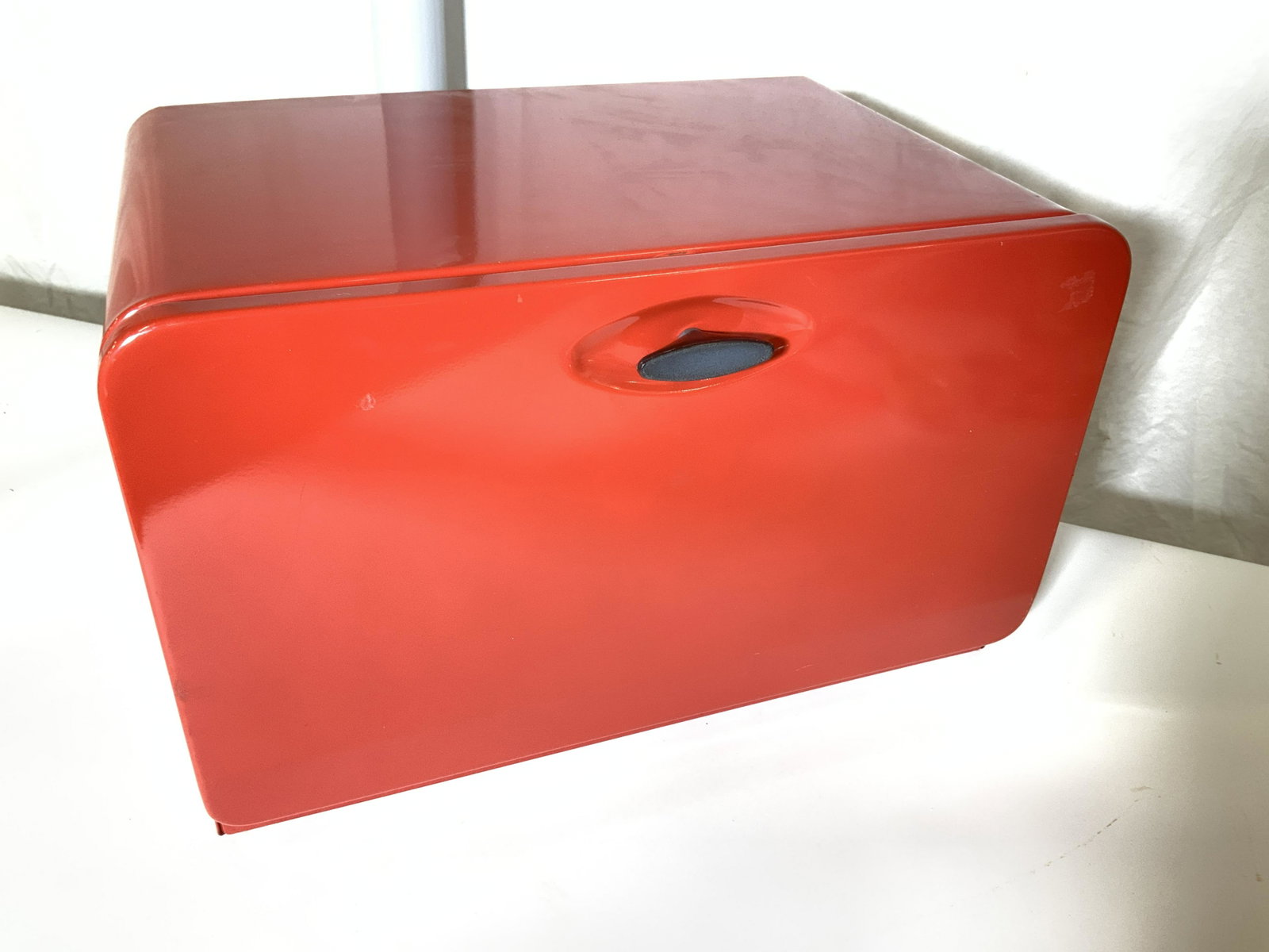 KCO Red Metal Breadbox, Kitchenalia: Large size metal bread box with shelf. Air holes on sides. Looks never used. Measures 16 3/8 in. L, 10.5 in ht, 10.25 in w. Hinged door folds down. Hallmarked KCO. Handle turns to open. Property of mu