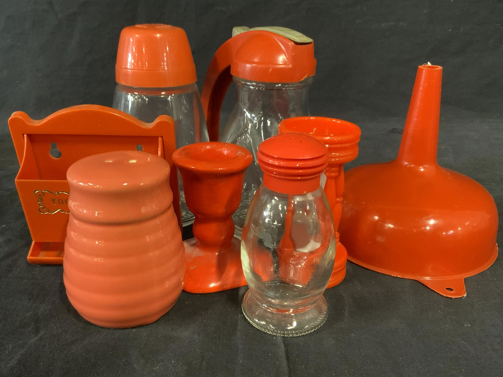 Lot 8 Vintage Orange Toned Cooking Accessories: Includes 2 seasoning shakers, 1 sifter, 1 egg timer, 1 funnel. 1 toothpick holder, 1 candlestick holder, and 1 Syrup Dispenser. All pieces are vintage. Wear is consistent with age and use. Crafted fro
