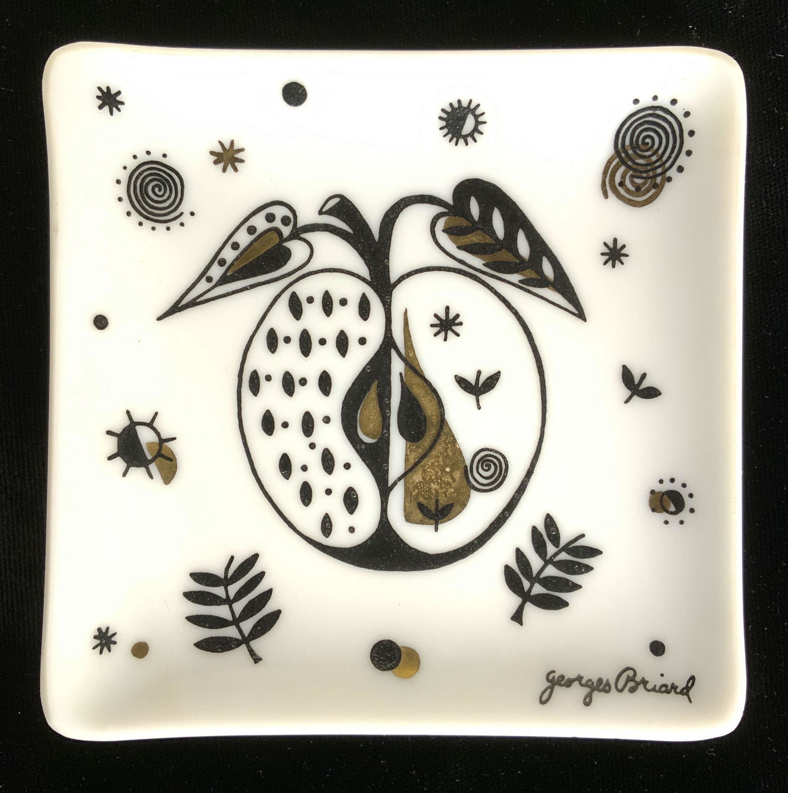 Pair GEORGES BRIARD Trinket Dishes: Each piece is marked GEORGES BRIARD. Trinket dishes are white with black & gold toned apple, vine, leaf & geometric detail. Each piece measures approx 4 inches square. Trinket dishes, Georges BRIARD t