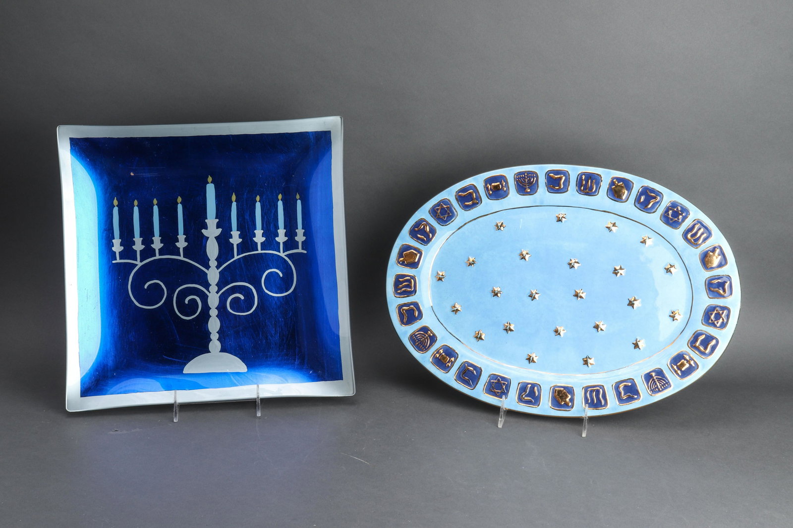 Judaica Chanukah Theme Serving Dishes, 2: Judaica Chanukah Theme Serving Dishes, 2 Group of two Chanukah themed serving dishes, one with a hand painted menorah marked "Imani International" the other ceramic with gilt painted Chanukah decorati