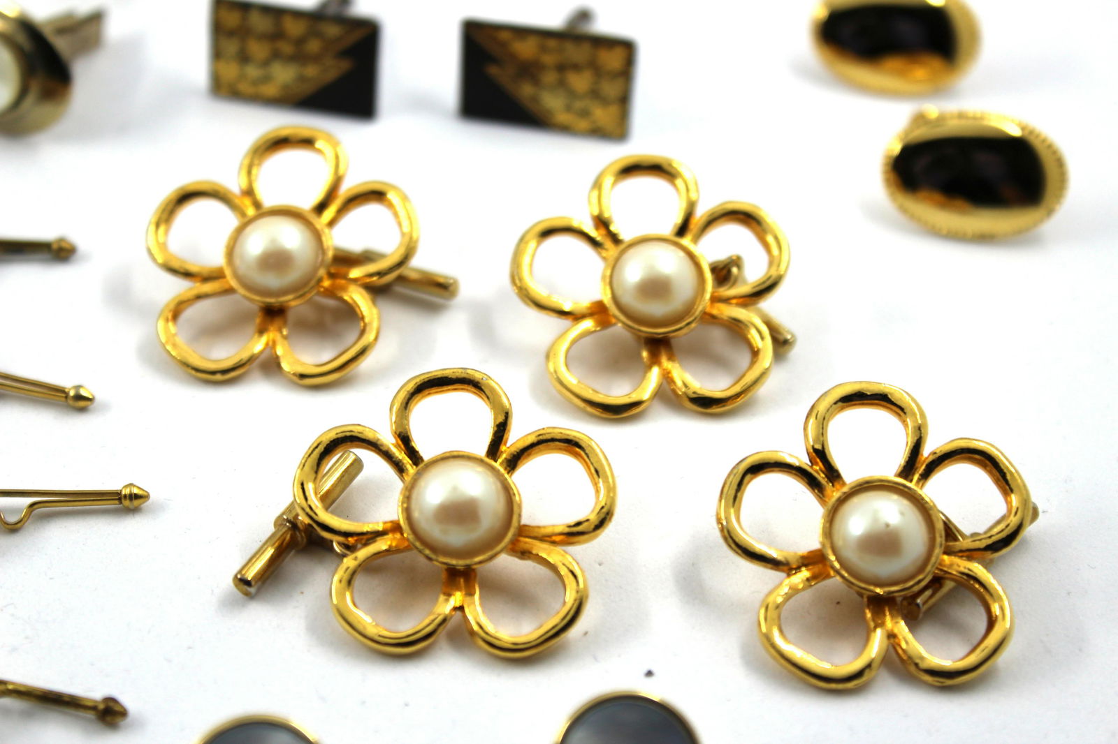 Assorted Costume Cuff Links, Accessories, 28: Assorted Costume Cuff Links, Accessories, 28 Assortment of fifteen pairs of costume cuff links, three pairs of gold-plated links with mother of pearl details, seven separates, two Swank tie clasps, on