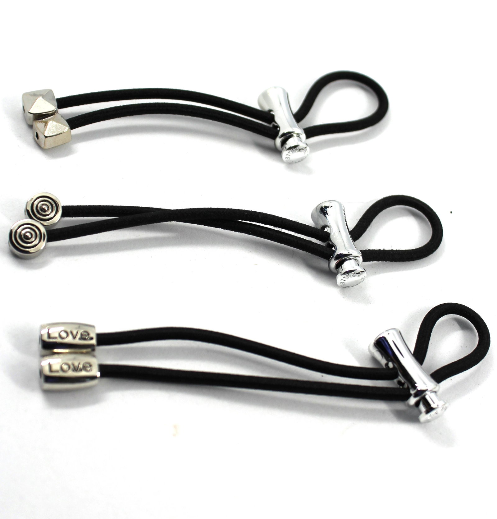 Pulleez Sliding Elastic Hair Ties, Group of 6: Pulleez Sliding Elastic Hair Ties, Group of 6 Pulleez sliding elastic hair ties, group of six, all with black elastic, three with gold colored hardware and three with silver colored hardware. Each: 4.