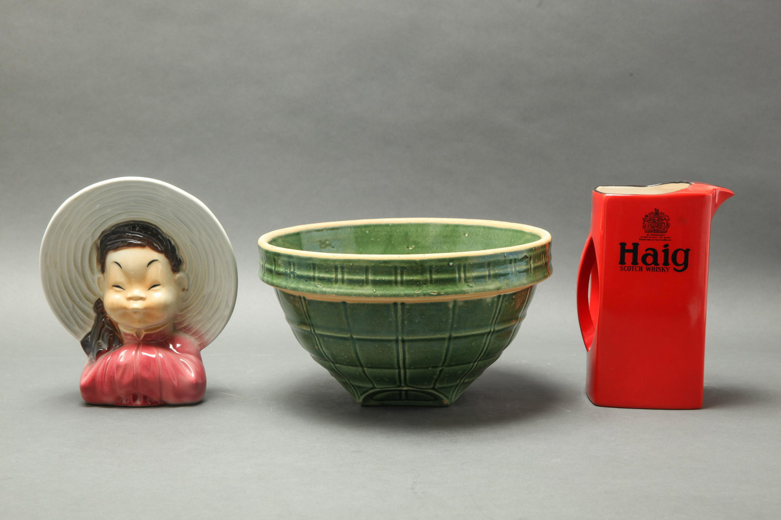 Group Of Glazed Pottery, 3: Group Of Glazed Pottery, 3 Group of glazed pottery, comprising a Royal Copley vessel Asian girl with a large hat, marked "Royal Copley", a green glazed earthenware bowl, and a red Haig scotch whiskey 