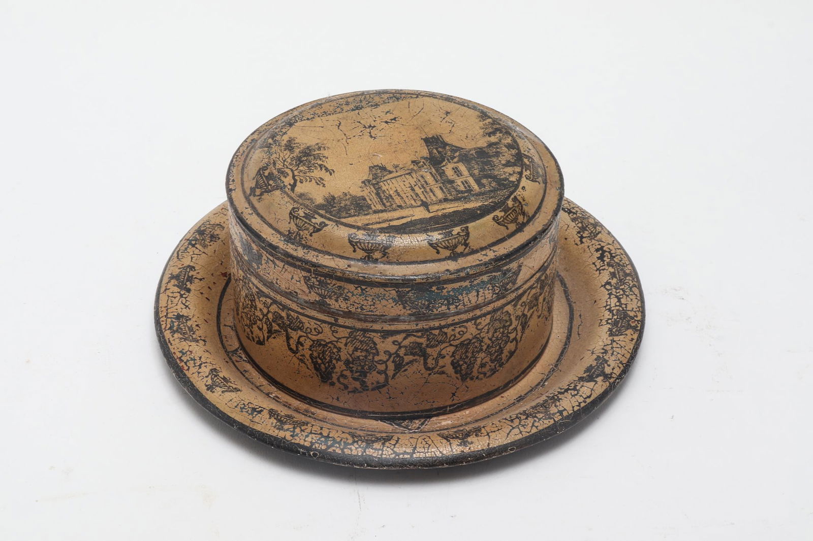 Toleware Hinged Box & Plate w Architectural Motifs: Toleware Hinged Box & Plate w Architectural Motifs Toleware articles including a round hinged lid box and a plate both with architectural motif decoration. Box: 3" H x 5" diameter. Age wear, loss to f
