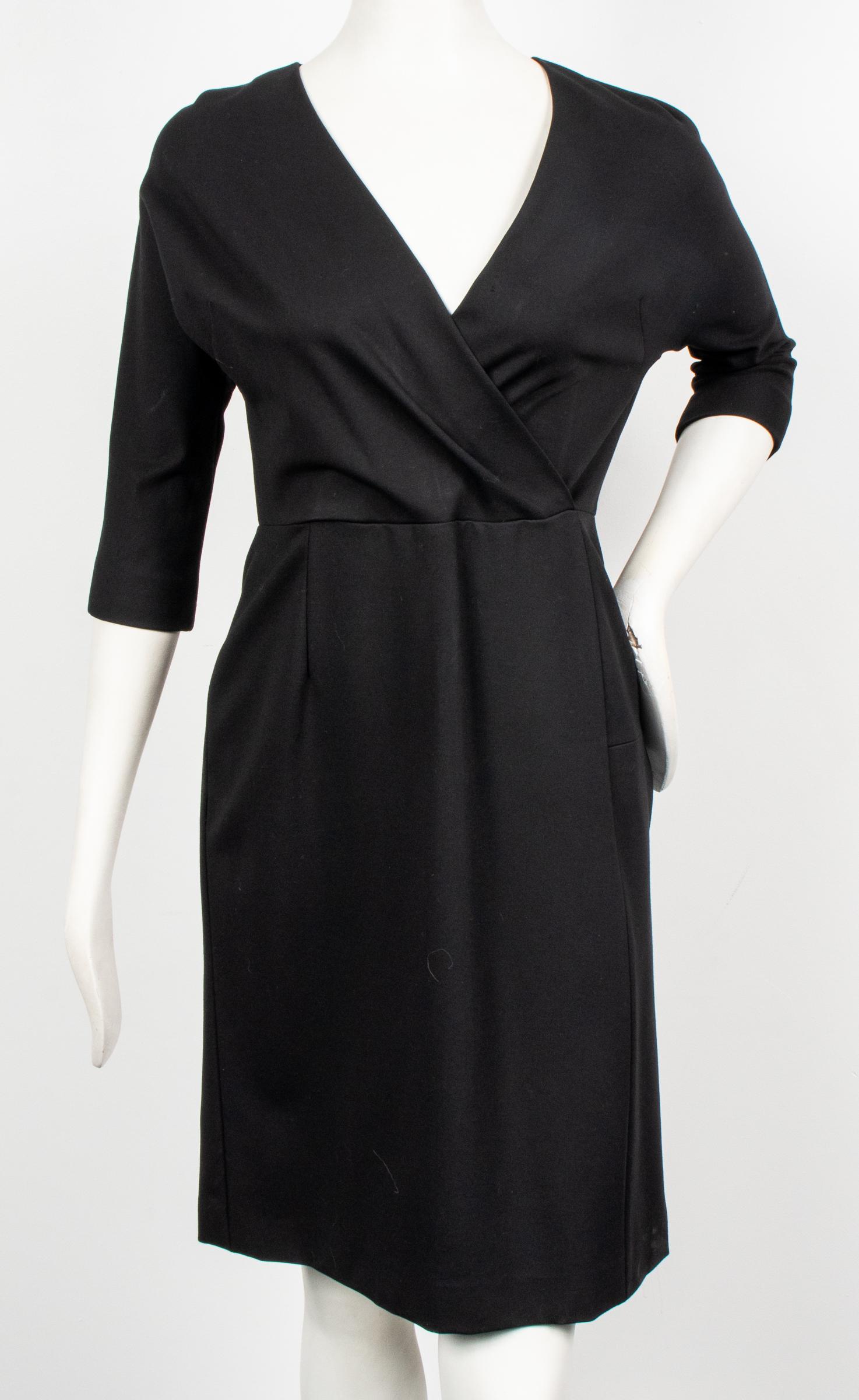 Jil Sander Black Fitted Dress: Jil Sander Black Fitted Dress Jil Sander dress with elbow length sleeves, surplice neckline, zippered back, fitted silhouette, designer's label and size "Jil Sander Made in Italy / 38" to interior. Sh