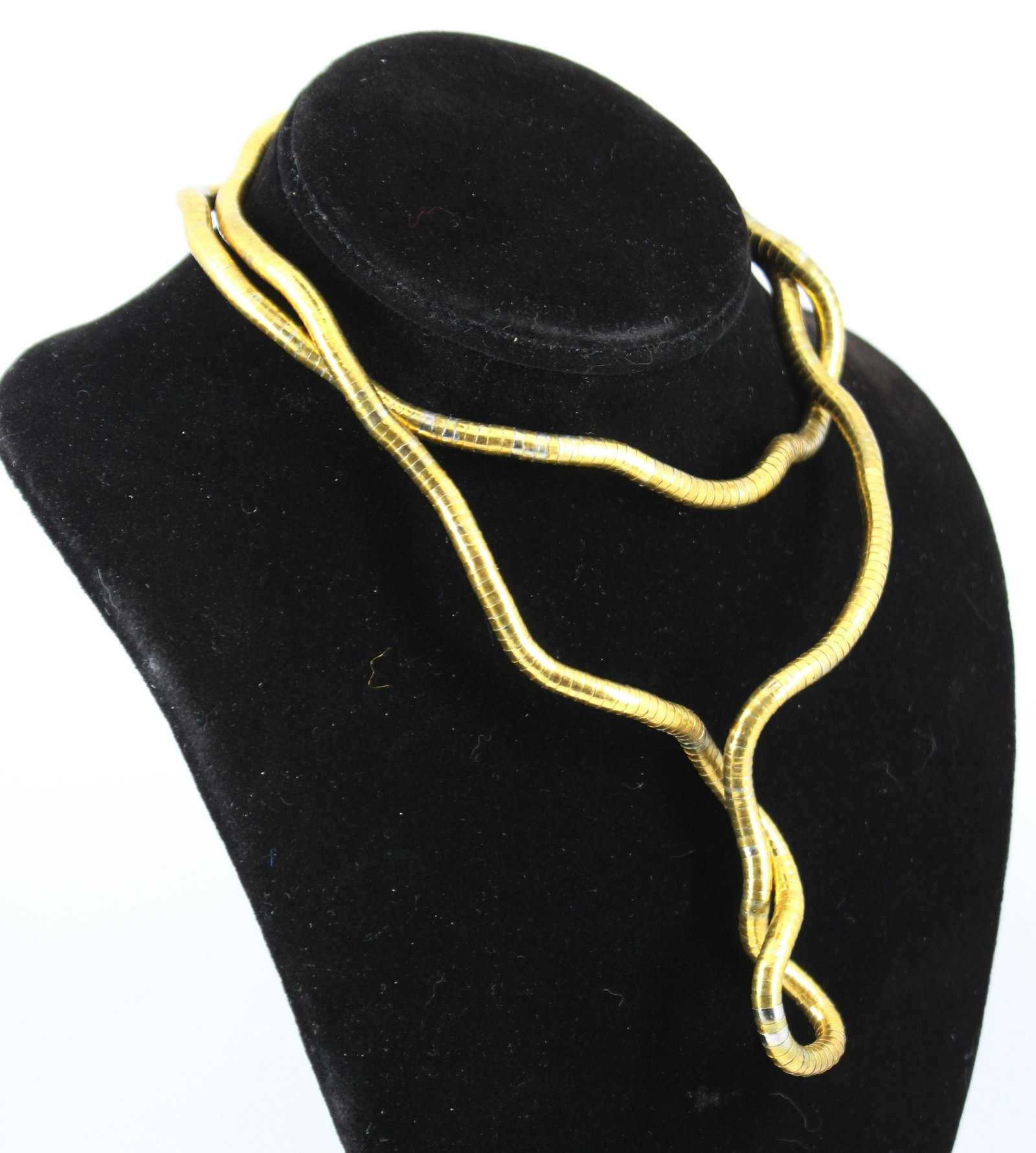Steel Omega Type Posable Gold-Tone Necklace: Steel Omega Type Posable Gold-Tone Necklace Steel omega type posable gold-tone continuos necklace. Hollow construction composed of hundreds of short cylinders stacked for flexibility and able to retai