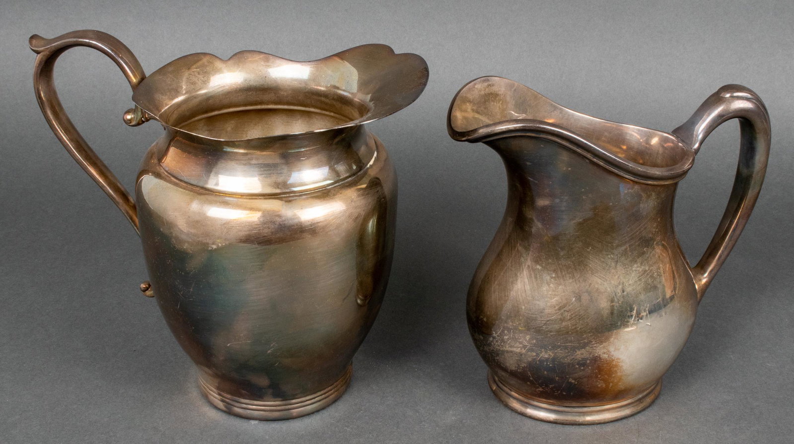 Sheffield & Wallace Silver Plated Pitchers, 2: Sheffield & Wallace Silver Plated Pitchers, 2 Two silver plated pitchers, one marked "The Sheffield Silver Co Made in USA EPC," the other "R. Wallace 050 Silver Soldered 3 pint." Tallest (Sheffield): 