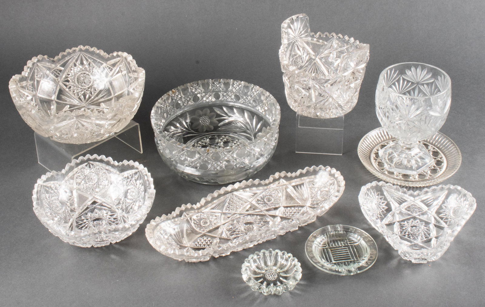Collection of Cut Crystal & Pressed Glass, 10 Pcs.: Collection of Cut Crystal & Pressed Glass, 10 Pcs. Group of 10 cut crystal and glass articles, Including three serving bowls, a wine coaster, triangular bowl, etc. Largest bowl: 3.5" H x 8" diameter.