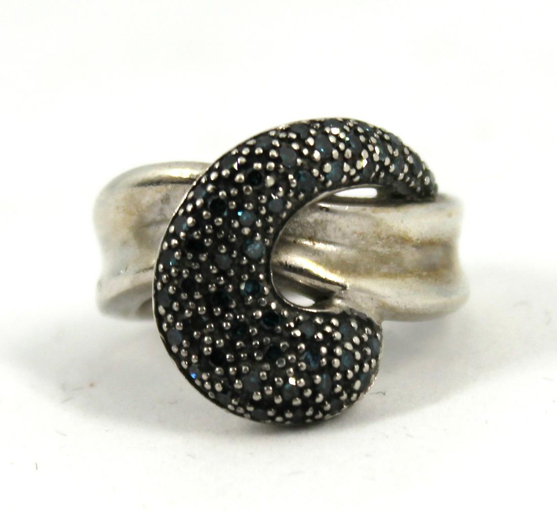 Silver Ring with Blue Irradiated Diamonds: Silver Ring with Blue Irradiated Diamonds Ring in sterling silver with 50 blue irradiated diamonds (0.30 ctw). Marked "925 J / CHINA." 1.0" L x 0.75" W. Ring size: 6. Approx. 0.25 ozt. (inclusive).