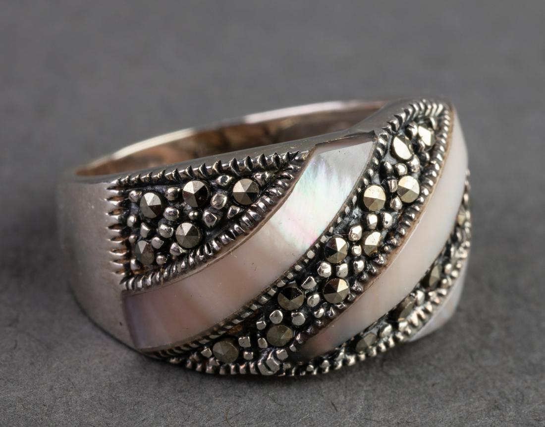 Mother-of-Pearl & Marcasite Sterling Silver Ring: Mother-of-Pearl & Marcasite Sterling Silver Ring Sterling silver ring with alternating mother-of-pearl and marcasite bands, marked "925 Thailand." Ring size: 7. Weight: 0.17 ozt inclusive.