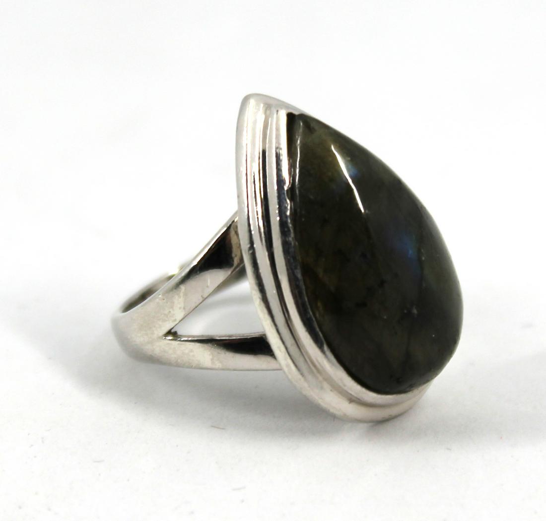 Silver Pear-Shaped Labradorite Ring: Silver Pear-Shaped Labradorite Ring Sterling silver ring with pear-shaped central labradorite stone. Unmarked. Measures 1.1025" L x 0.75" W. Labradorite measures 22 mm. x 13 mm. Ring size: 7. Approx: