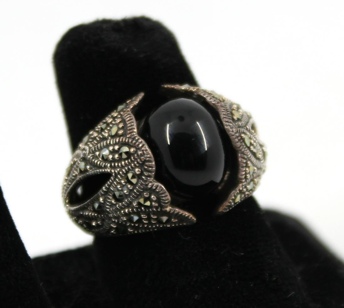 Silver, Onyx & Marcasite Ornate Ring: Silver, Onyx & Marcasite Ornate Ring Ornate ring in sterling silver with onyx and marcasite marked "NF / 925 / THAILAND." Measuring 1.0" L x 0.625" W. Ring size: 7. Approx: 0.27 ozt. inclusive.
