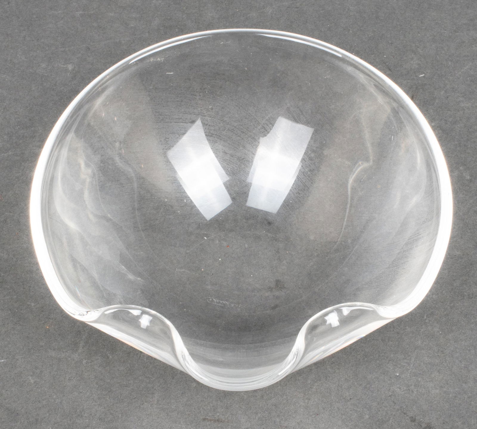 Steuben Crystal Modern Bowls, 2: Steuben Crystal Modern Bowls, 2 Group of two Steuben crystal modern bowls, one being oval in form with a scalloped foliate rim, the other with a free form rim, each signed to underside "Steuben." Larg